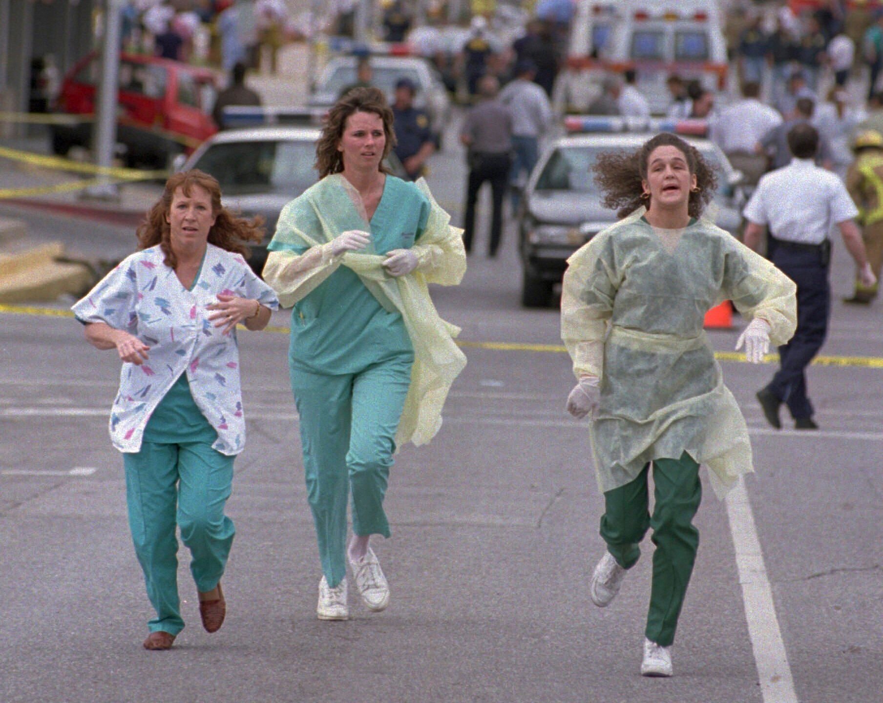 FILE - Medical assistants Janet Froehlich, Wilma Jackson and Kerri Albright run from the Alfred P. Murrah Federal Building after being told another bomb device had been found on April 19, 1995, in Oklahoma City. (AP Photo/David J. Phillip, File)