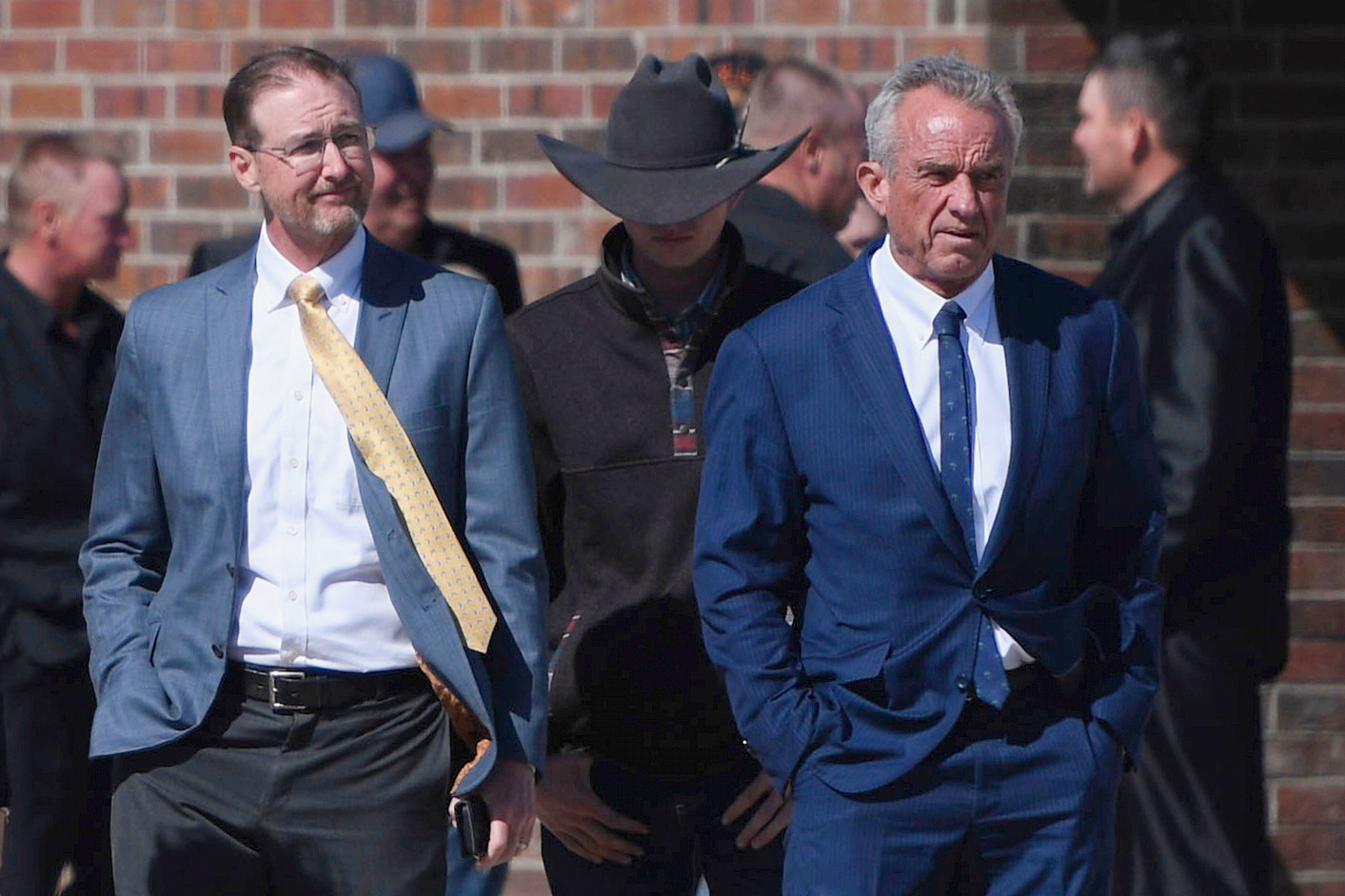 FILE - Health and Human Services Secretary Robert F. Kennedy Jr., right, stands with Dr. Ben Edwards, left, outside the Reinlander Mennonite Church in Seminole, Texas, on Sunday, April 6, 2025, after a second measles death. (AP Photo/Annie Rice, File)