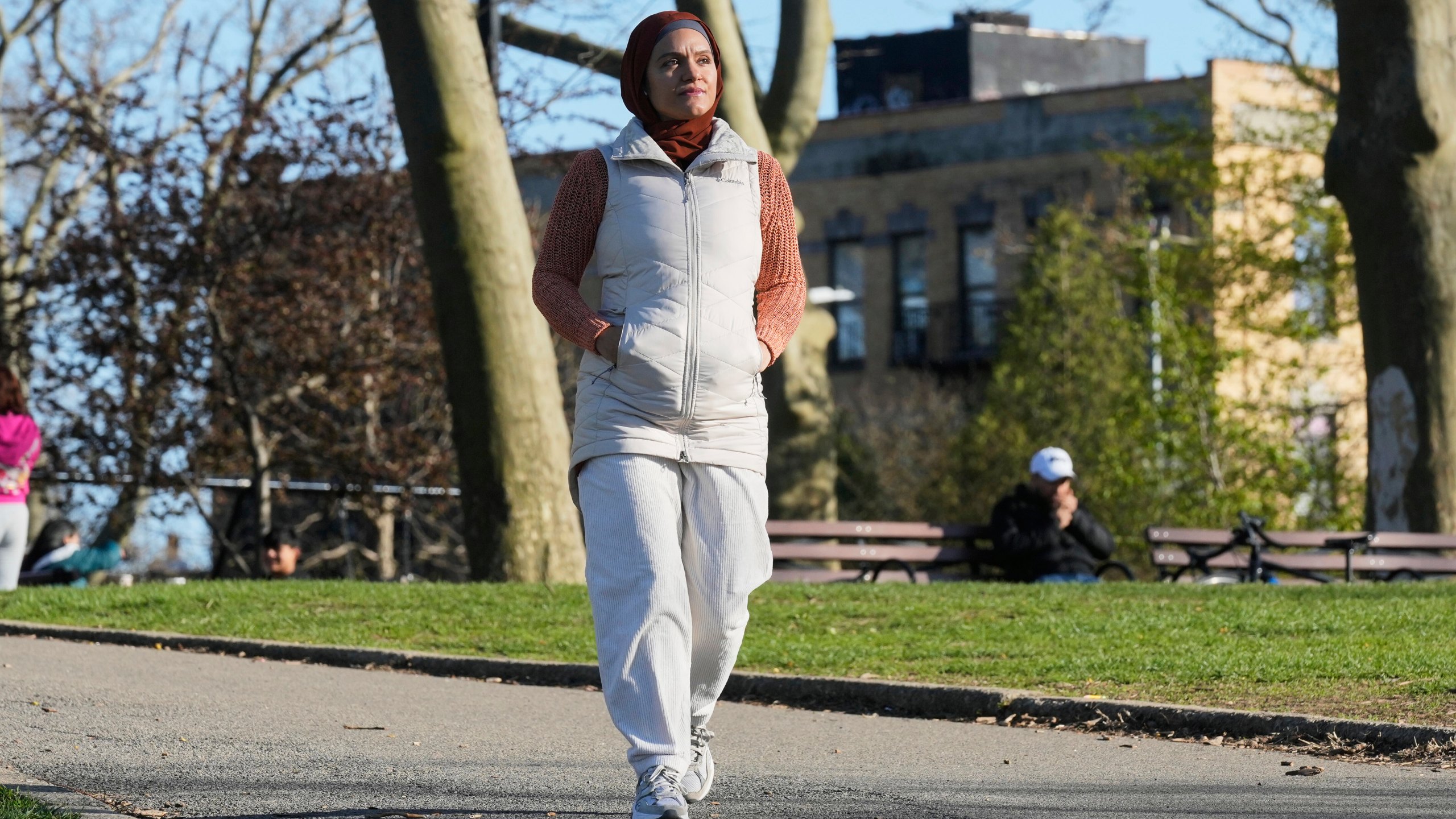 Daniris Espinal walks through Sunset Park, in the Brooklyn borough of New York, Thursday, April 17, 2025. (AP Photo/Richard Drew)