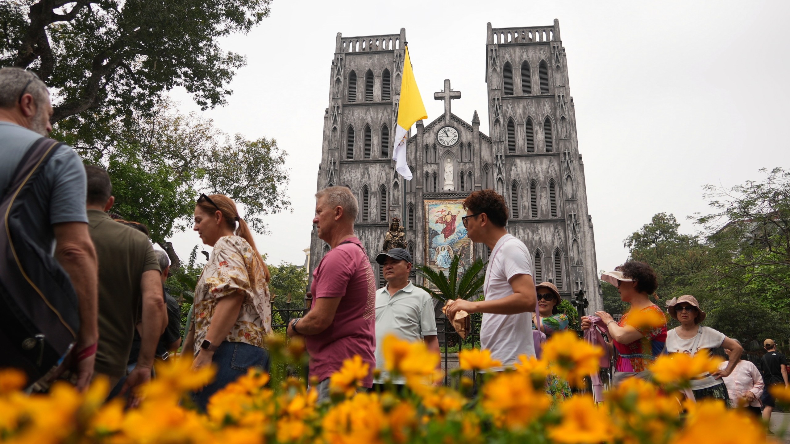 Tourists visit the St. Joseph's Cathedral in Hanoi, Vietnam, Tuesday, April 22, 2025. (AP Photo/Hau Dinh)