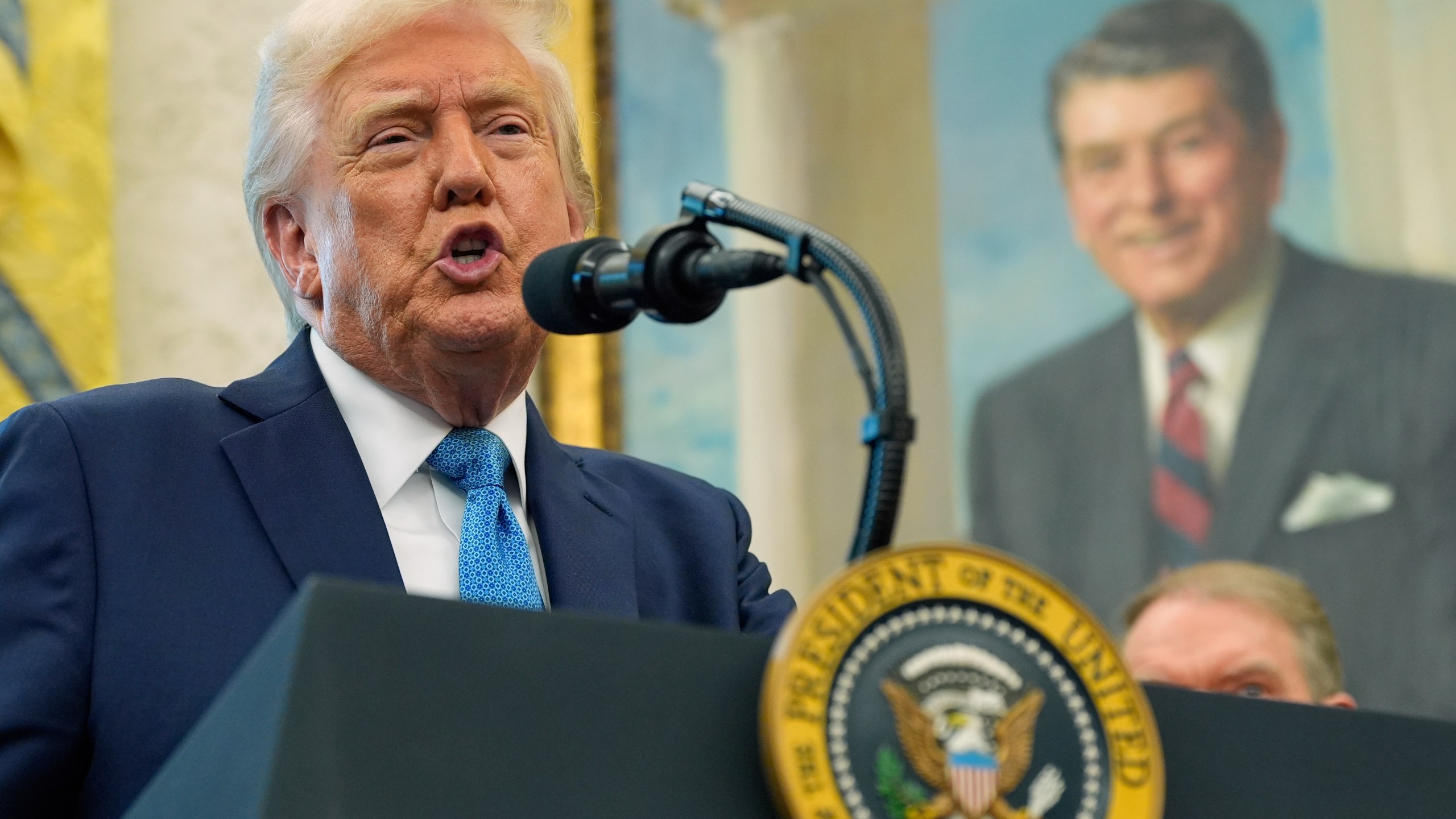 President Donald Trump speaks with reporters as he participates in a ceremonial swearing in of Paul Atkins as chairman of the Securities and Exchange Commission, in the Oval Office of the White House, Tuesday, April 22, 2025, in Washington. (AP Photo/Alex Brandon)