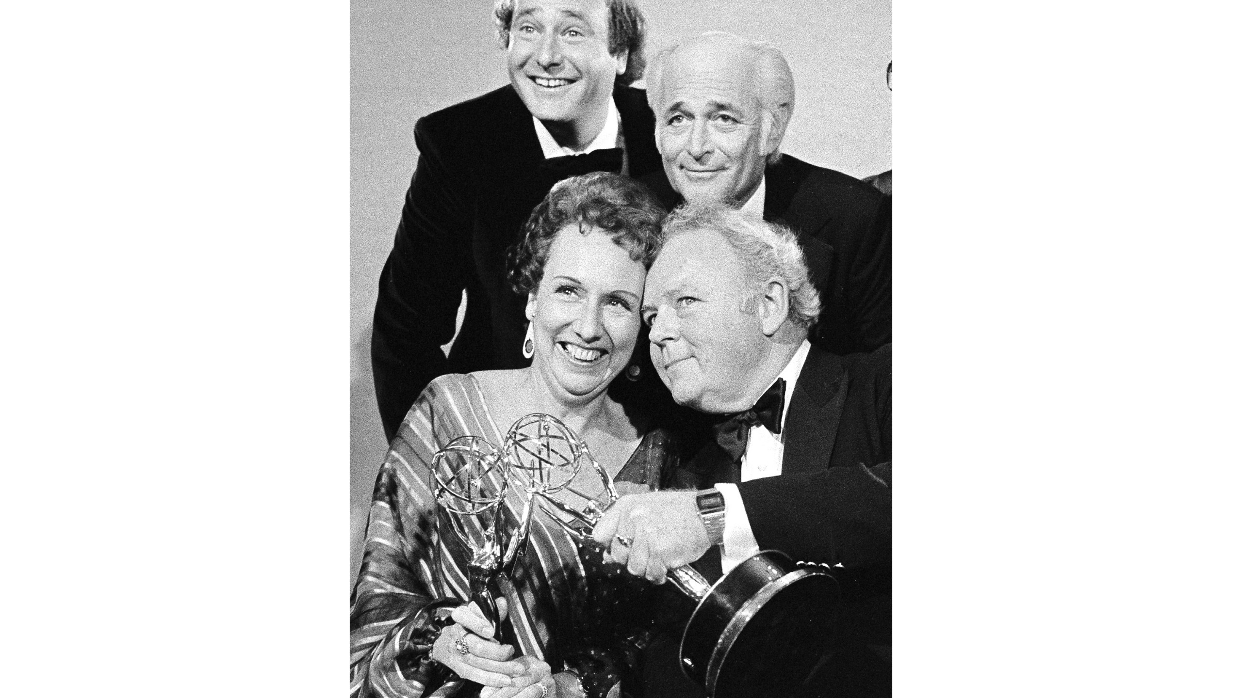 FILE - Actors Jean Stapleton, seated, left, and Carroll O'Connor, seated, right, hold their Emmys for “All in the Family” after receiving them on Sept. 18, 1978, in Los Angeles. At rear, from left to right are Rob Reiner, who won an Emmy for supporting actor in the same series; Norman Lear, producer of the show; and executive producer Mort Lachman. (AP Photo, File)