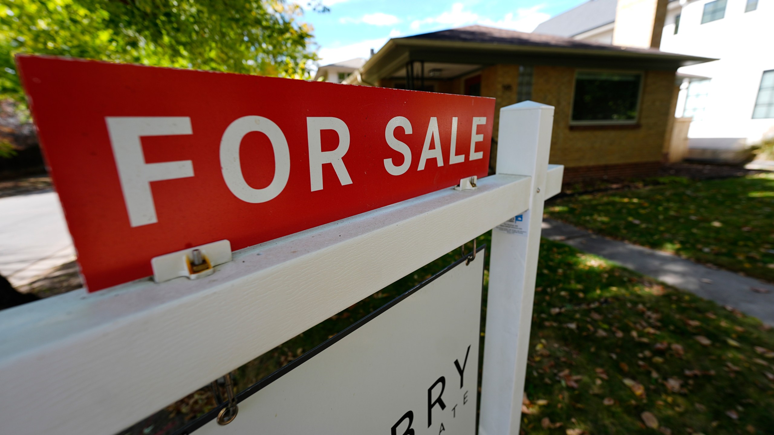 FILE - A sale sign stands outside a home on the market Thursday, Oct. 17, 2024, in the east Washington Park neighborhood of Denver. (AP Photo/David Zalubowski, File)