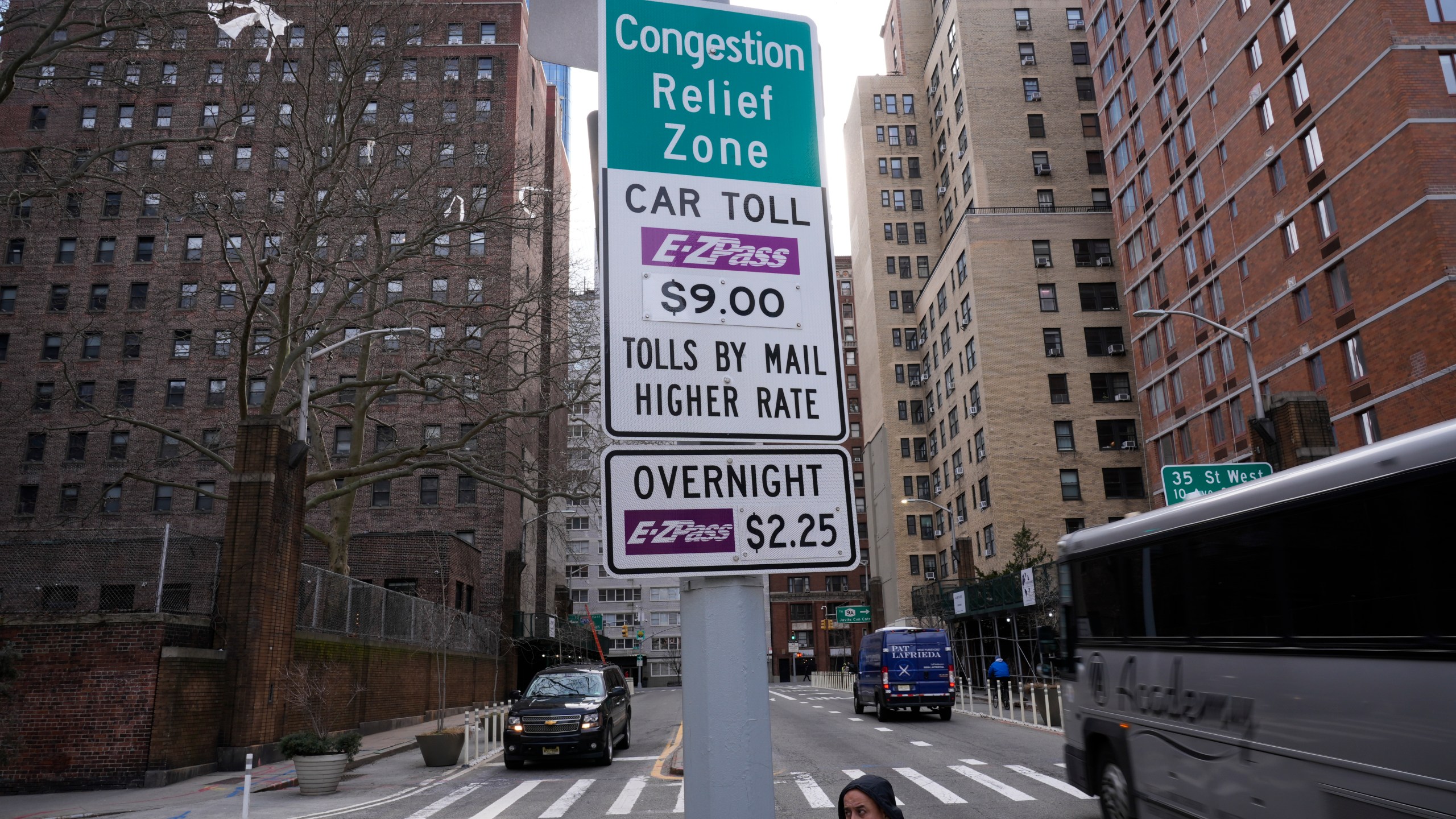 FILE - Signs advising drivers of congestion pricing tolls are displayed near the exit of the Lincoln Tunnel in New York, Wednesday, Feb. 19, 2025. (AP Photo/Seth Wenig, File)