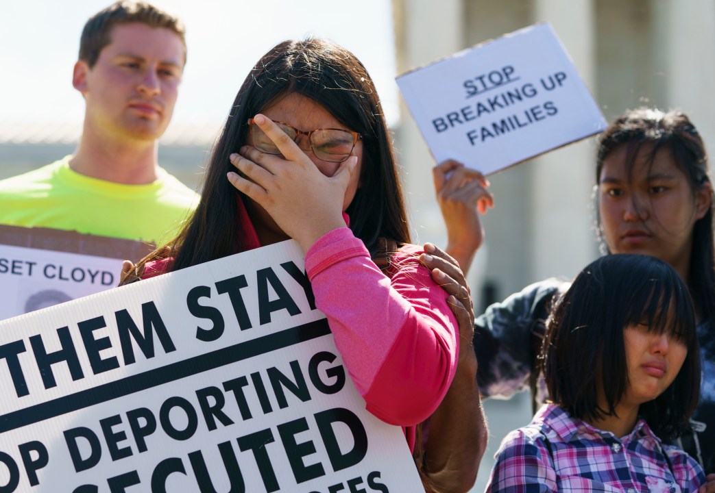 FILE - Caitlin Sanger, of Franklin Park, N.J., pauses to cry outside the Supreme Court in Washington, June 26, 2018, as she speaks about her father being detained by ICE and protests immigrant families being split up. (AP Photo/Carolyn Kaster, file)