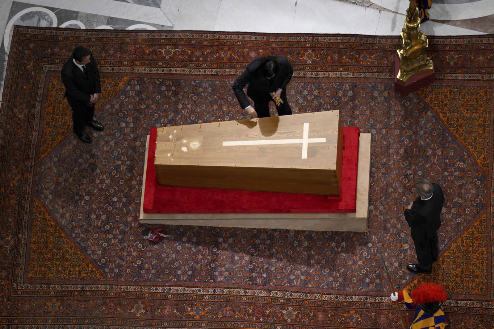 Cerimonial ushers close the casket containing the body of Pope Francis in St. Peter's Basilica at the Vatican Friday, April 25, 2025. (Vatican Media via AP)