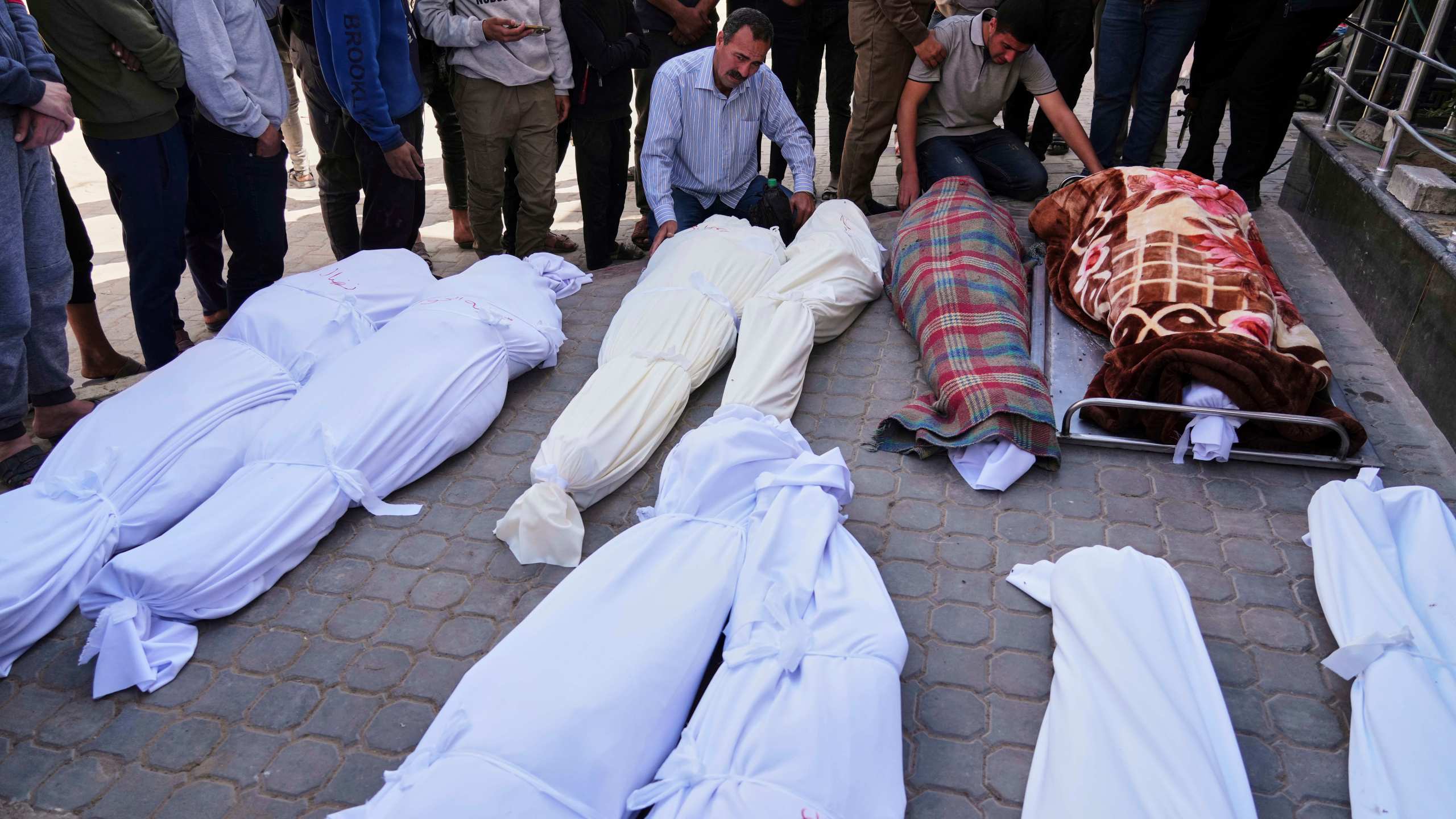 Palestinians mourn over the bodies of their relatives who were killed in an Israeli airstrike, as they brought to Shifa Hospital in Gaza City, on Saturday, April 26, 2025. (AP Photo/Jehad Alshrafi)