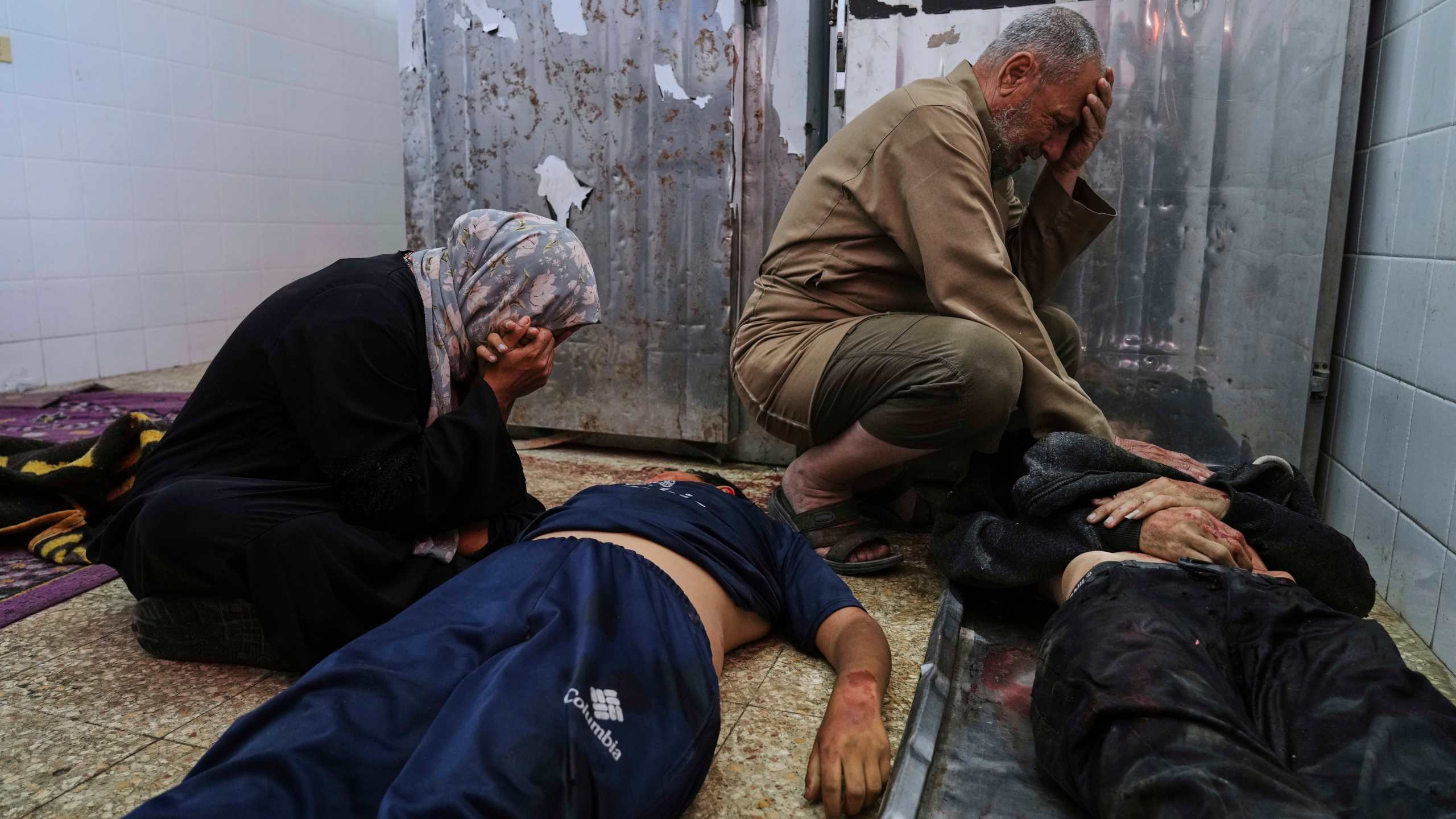 Palestinian mourn their relatives who were killed in an Israeli army airstrike on the Gaza Strip, at the morgue of Al-Aqsa Hospital in Deir al-Balah, Gaza, Sunday, April 27, 2025. (AP Photo/Abdel Kareem Hana)