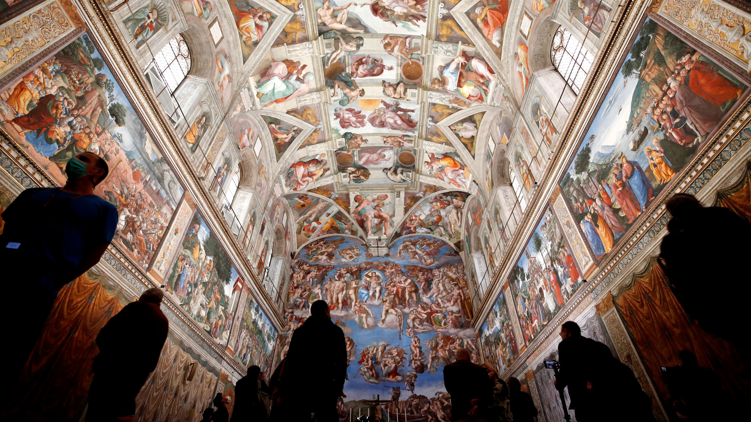 FILE - Visitors admire the Sistine Chapel inside the Vatican Museums on the occasion of the museum's reopening, in Rome, May 3, 2021. (AP Photo/Alessandra Tarantino, file)