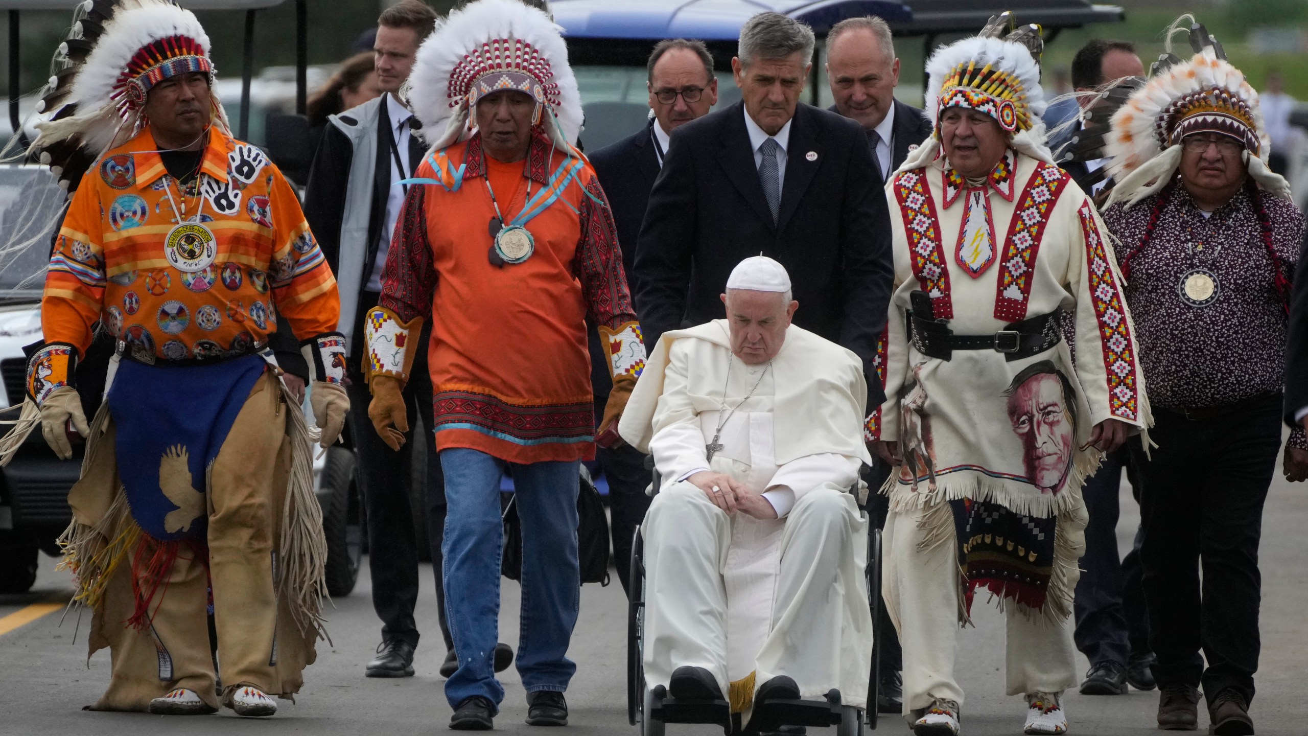 FILE - Pope Francis leaves with Indigenous peoples after praying in a cemetery at the former residential school in Maskwacis, near Edmonton, Canada, July 25, 2022. (AP Photo/Gregorio Borgia, File)