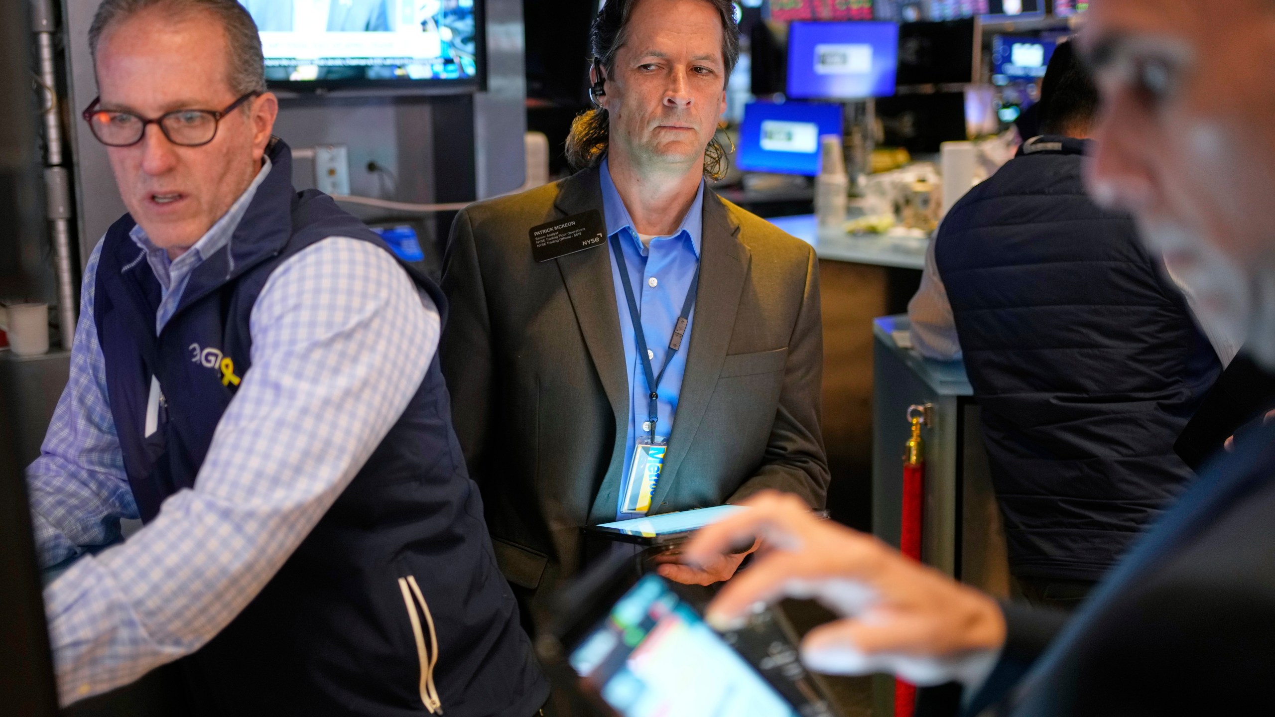 Patrick McKeon, center, works on the floor at the New York Stock Exchange in New York, Wednesday, April 30, 2025. (AP Photo/Seth Wenig)