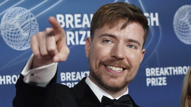 MrBeast points while smiling at an event