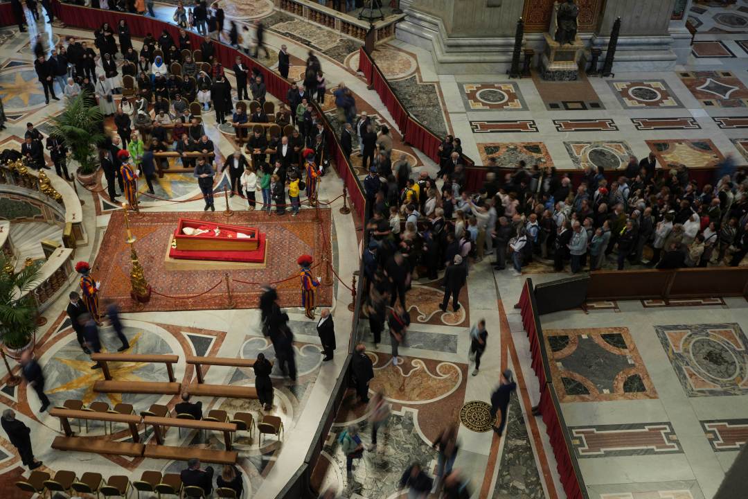 A line of people waiting to view Pope Francis' coffin inside a church