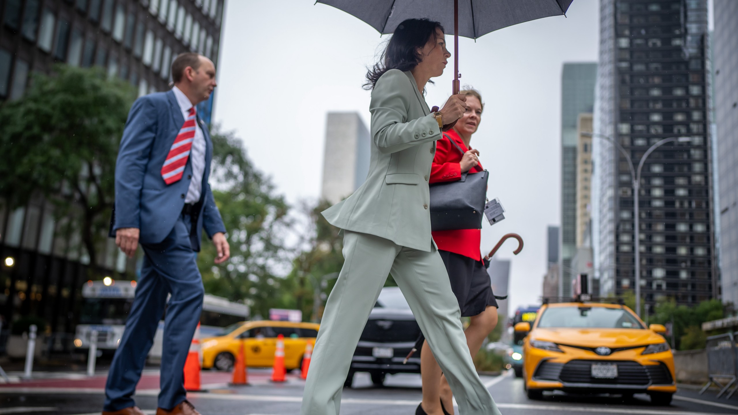 UN dignitaries walk across the street followed by a Secret Service bodyguard on the sidelines of the 79th General Debate of the UN General Assembly.