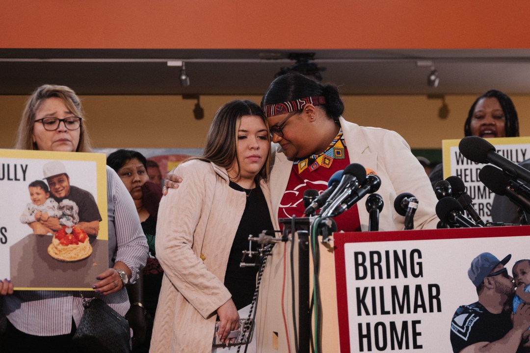 Jennifer Vasquez Sura is hugged by a staffer during a news conference