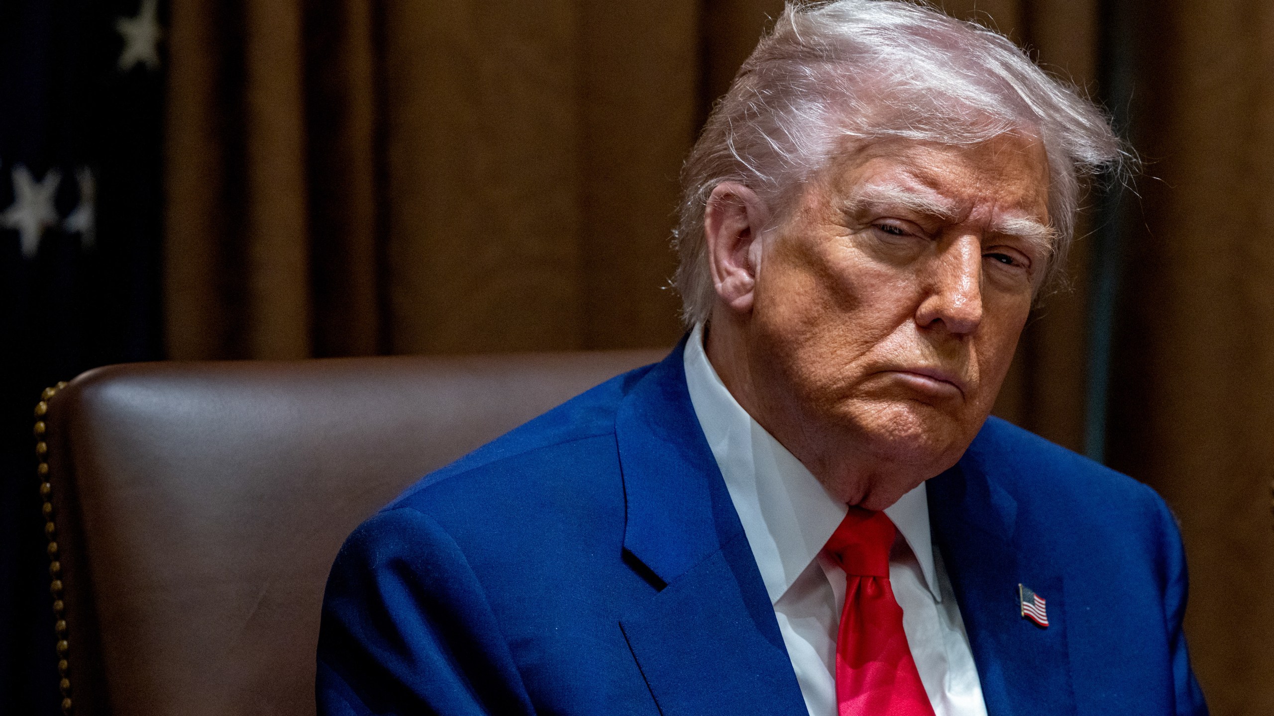 President Donald Trump listens during a meeting