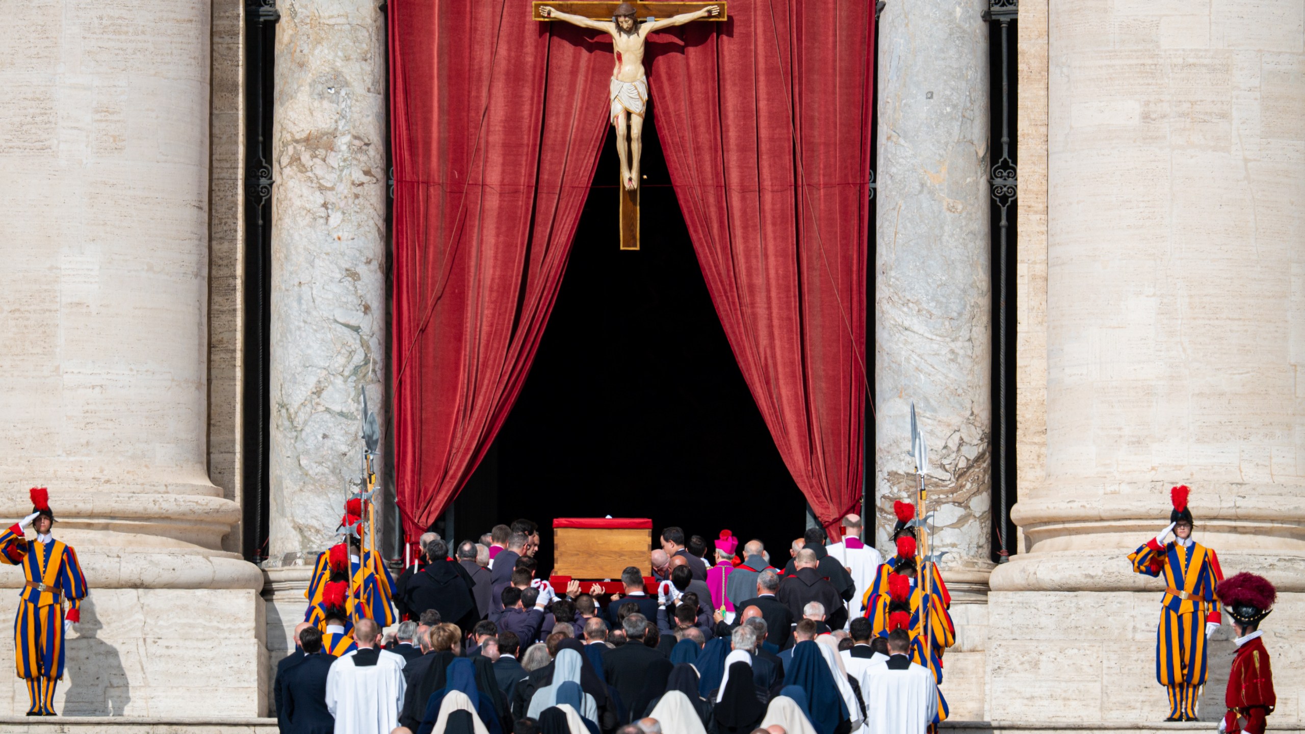 The ceremony with Pope Francis' body passes through the crowd at the Vatican.