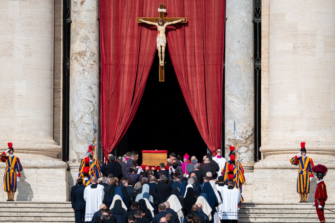 The ceremony with Pope Francis' body passes through the crowd at the Vatican.