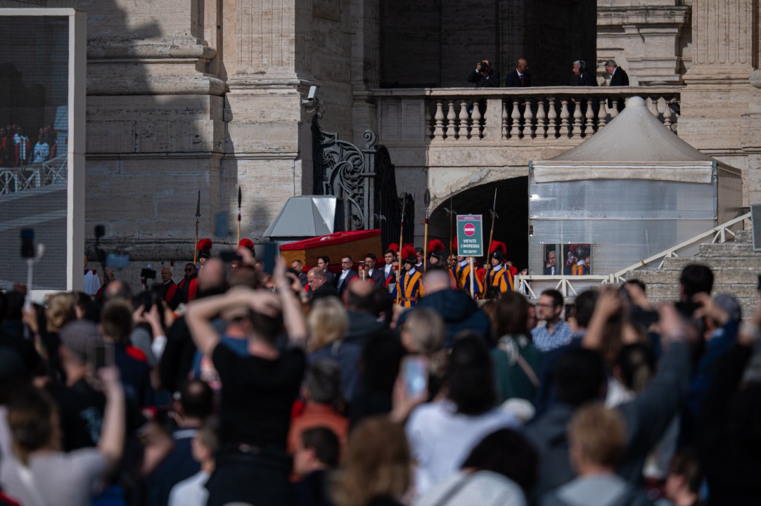 The ceremony with Pope Francis' body passes through the crowd at the Vatican.