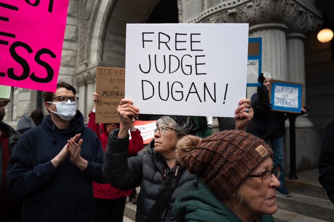 Demonstrators protest in front of the federal courthouse in support of Judge Hannah Dugan