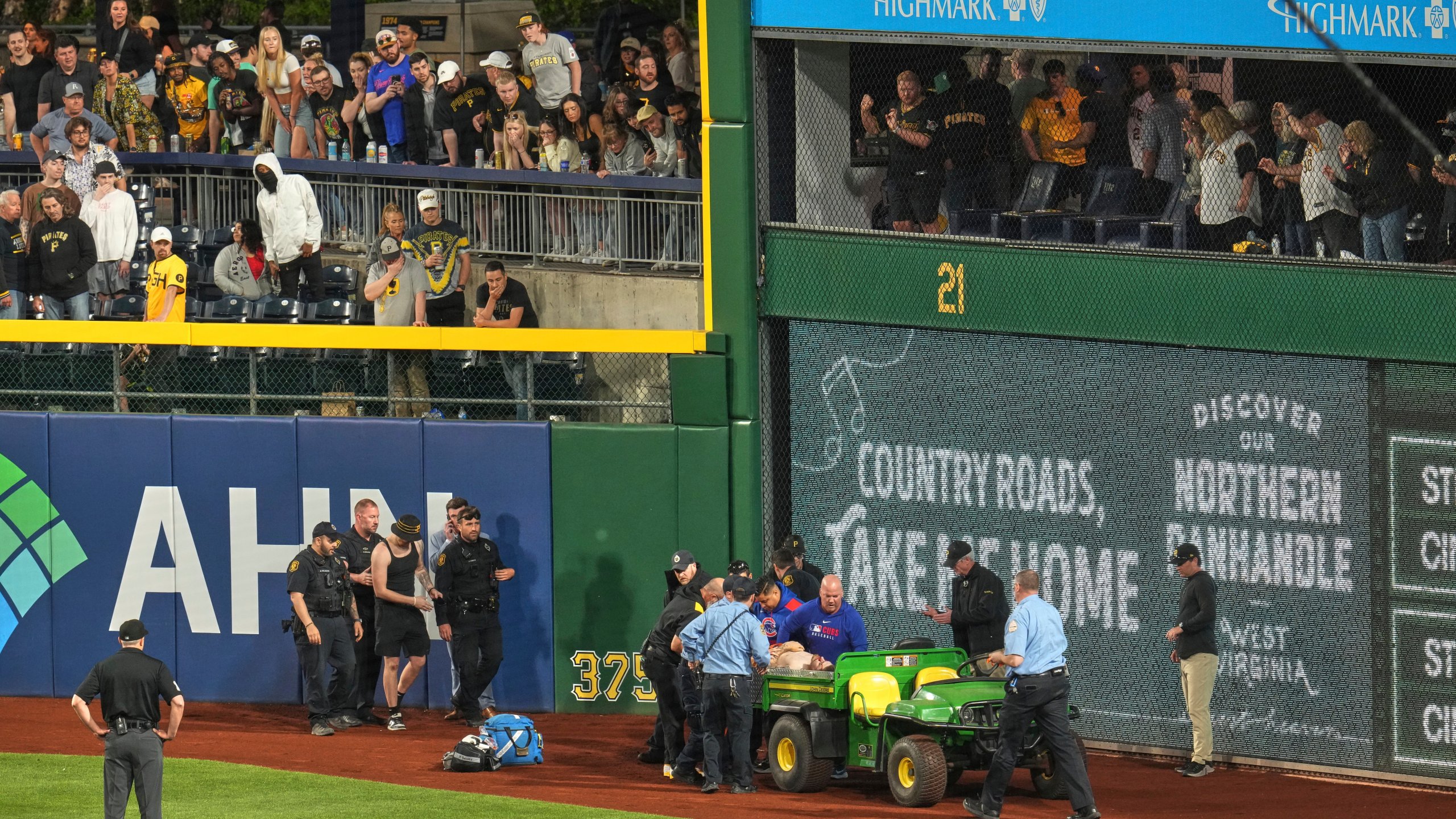 A fan is carted off the field at PNC Park after falling out of the stands during the seventh inning of a baseball game between the Pittsburgh Pirates and the Chicago Cubs in Pittsburgh, Wednesday, April 30, 2025. (AP Photo/Gene J. Puskar)
