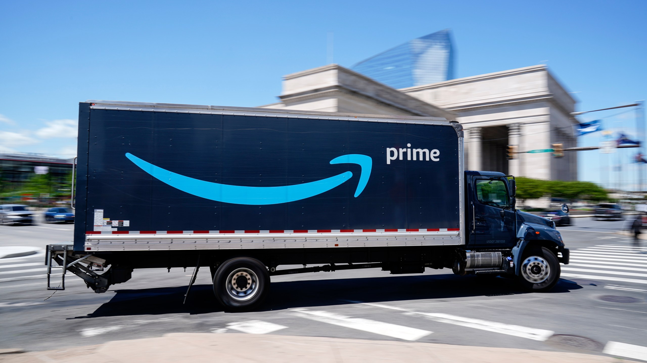 A blue Amazon truck drives in to a warehouse parking lot in Philadelphia, Friday, April 30, 2021.
