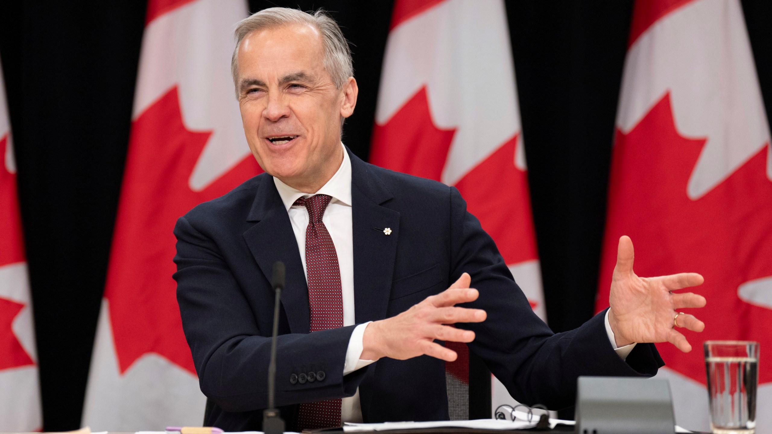 Prime Minister Mark Carney laughs as he responds to a question during a news conference