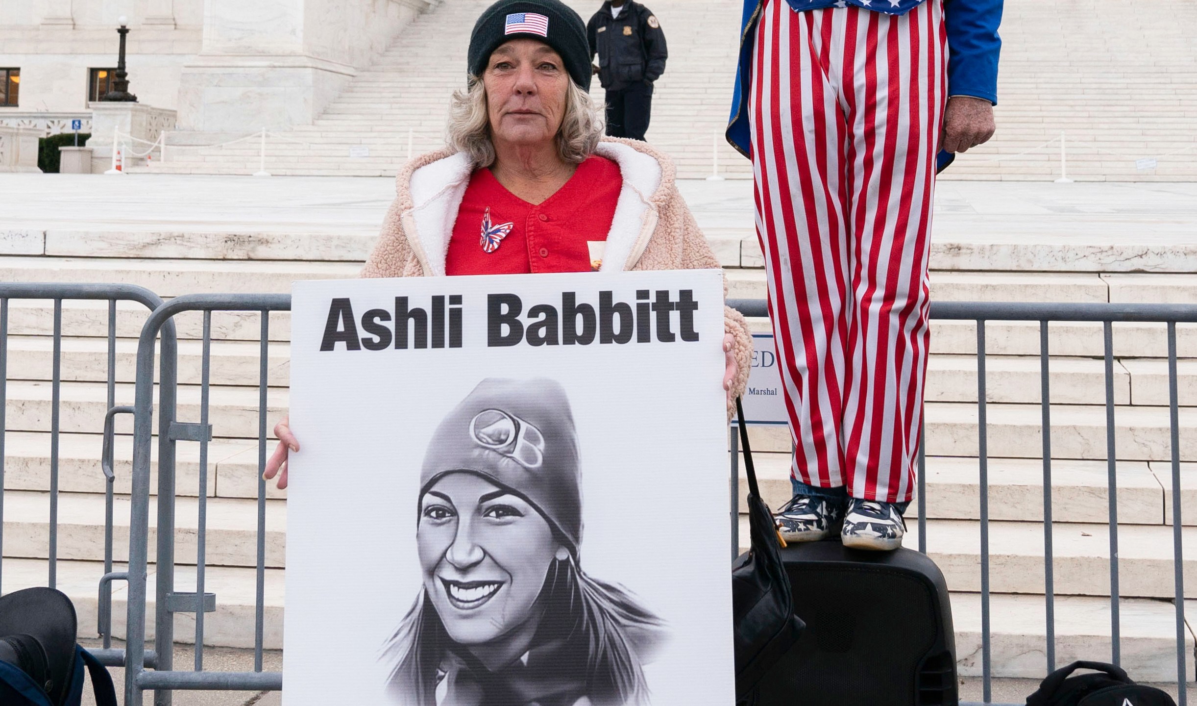 FILE - Micki Witthoeft, center, mother of Ashli Babbitt, the woman fatally shot by police inside the U.S. Capitol during the Jan. 6, 2021, riot, joins protesters outside of the Supreme Court on the second anniversary of the Jan. 6, assault on the U.S. Capitol, in Washington,, Jan. 6, 2023. (AP Photo/Jose Luis Magana)