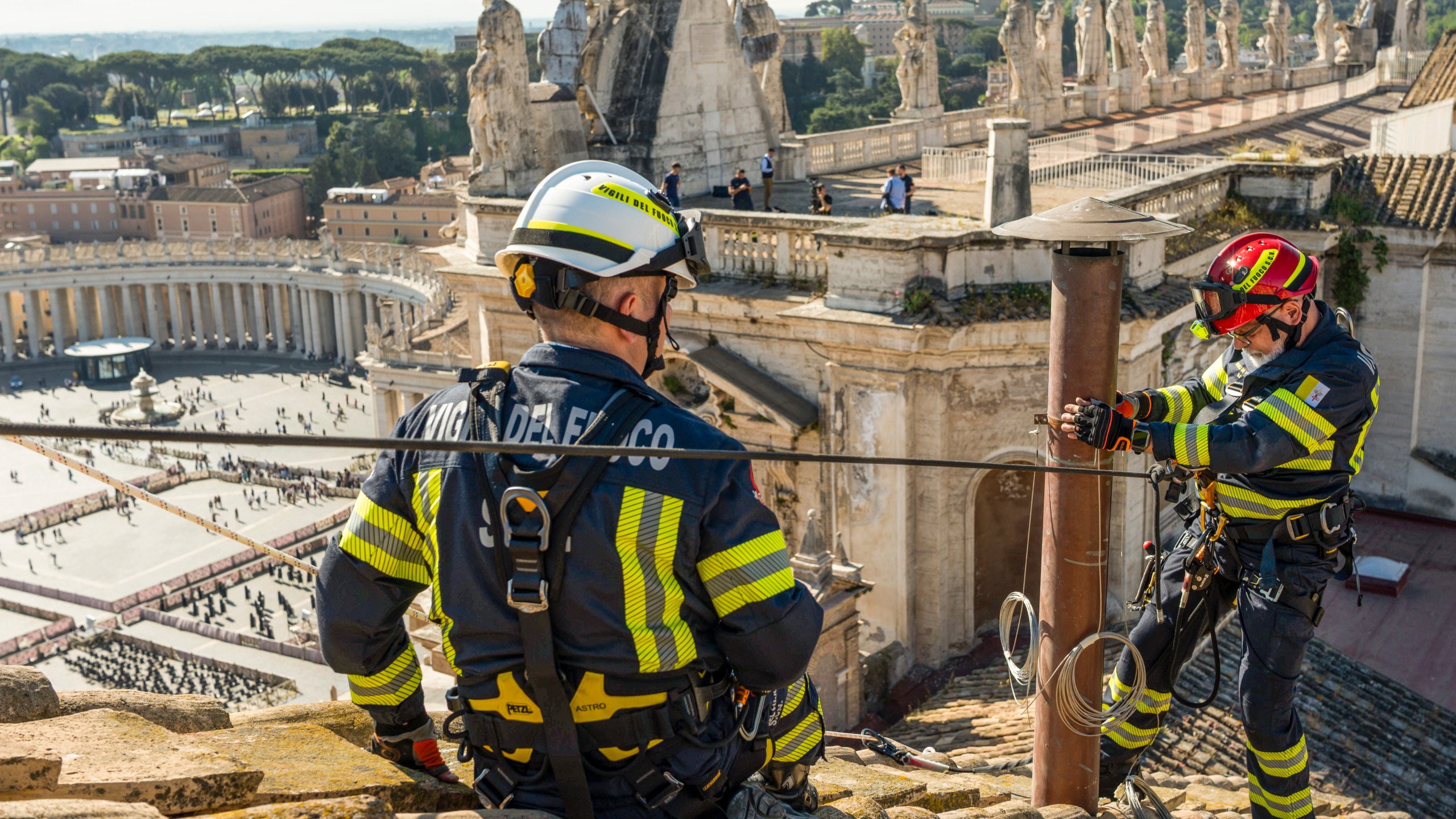 In this image taken on Friday, May 2, 2025, and made available Saturday, May 3, 2025, by Vatican Media, Italian firefighters install a temporary chimney on the roof of the Sistine Chapel at the Vatican, which will release smoke signals—black or white—from the upcoming conclave starting May 7, indicating whether a new pope has been elected. (Vatican Media via AP)