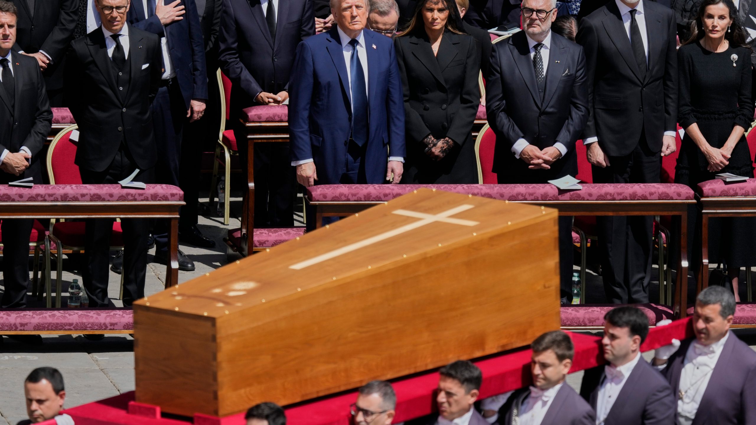 The coffin of Pope Francis is carried in front of dignitaries, including President Donald Trump, center, during his funeral in St. Peter's Square at the Vatican, Saturday, April 26, 2025. (AP Photo/Gregorio Borgia)