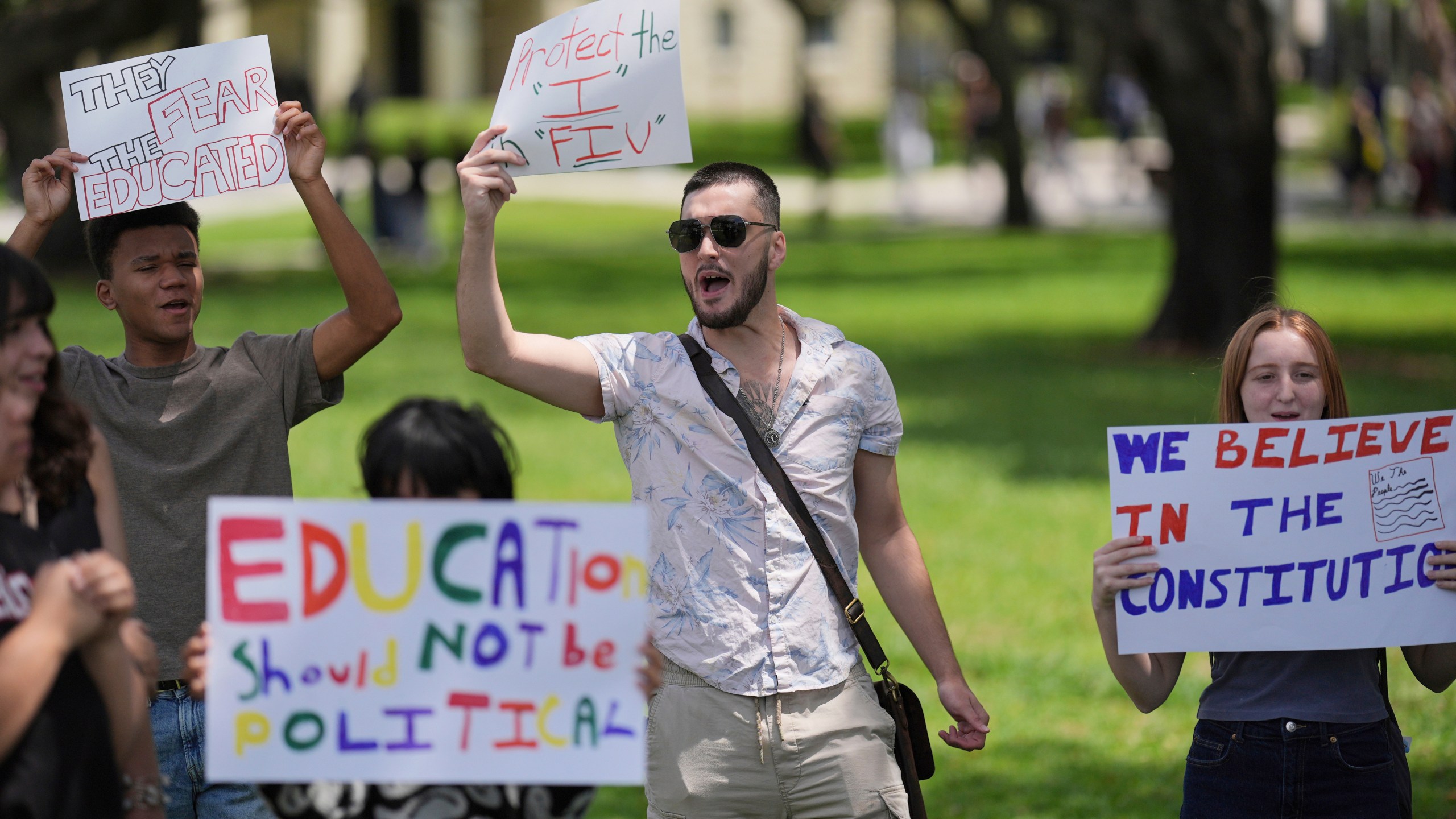FILE - A group of Florida International University students protest against cuts in federal funding and an agreement by campus police to partner with Immigration and Customs Enforcement, on the FIU campus on a day of protests around the country in support of higher education, Thursday, April 17, 2025, in Miami. (AP Photo/Rebecca Blackwell, File)
