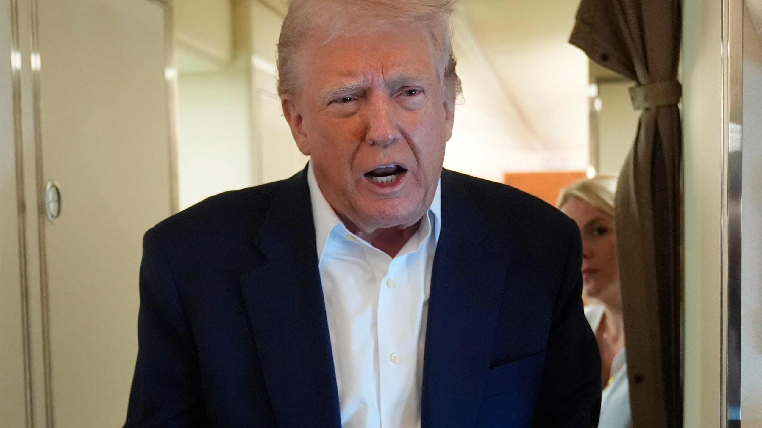President Donald Trump talks with reporters on Air Force One as he heads back to Washington, Sunday, May 4, 2025, from West Palm Beach, Fla. (AP Photo/Manuel Balce Ceneta)