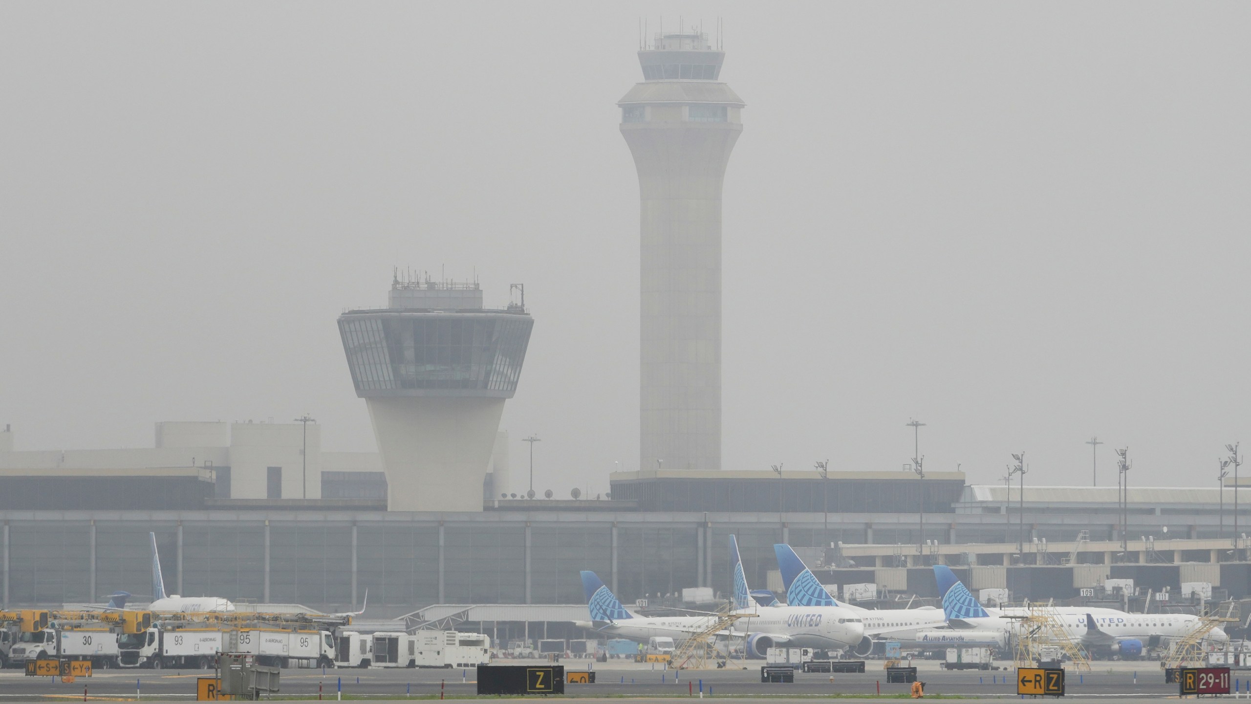 Fog covers planes and control towers at Newark Liberty International Airport in Newark, N.J., Monday, May 5, 2025. (AP Photo/Seth Wenig)