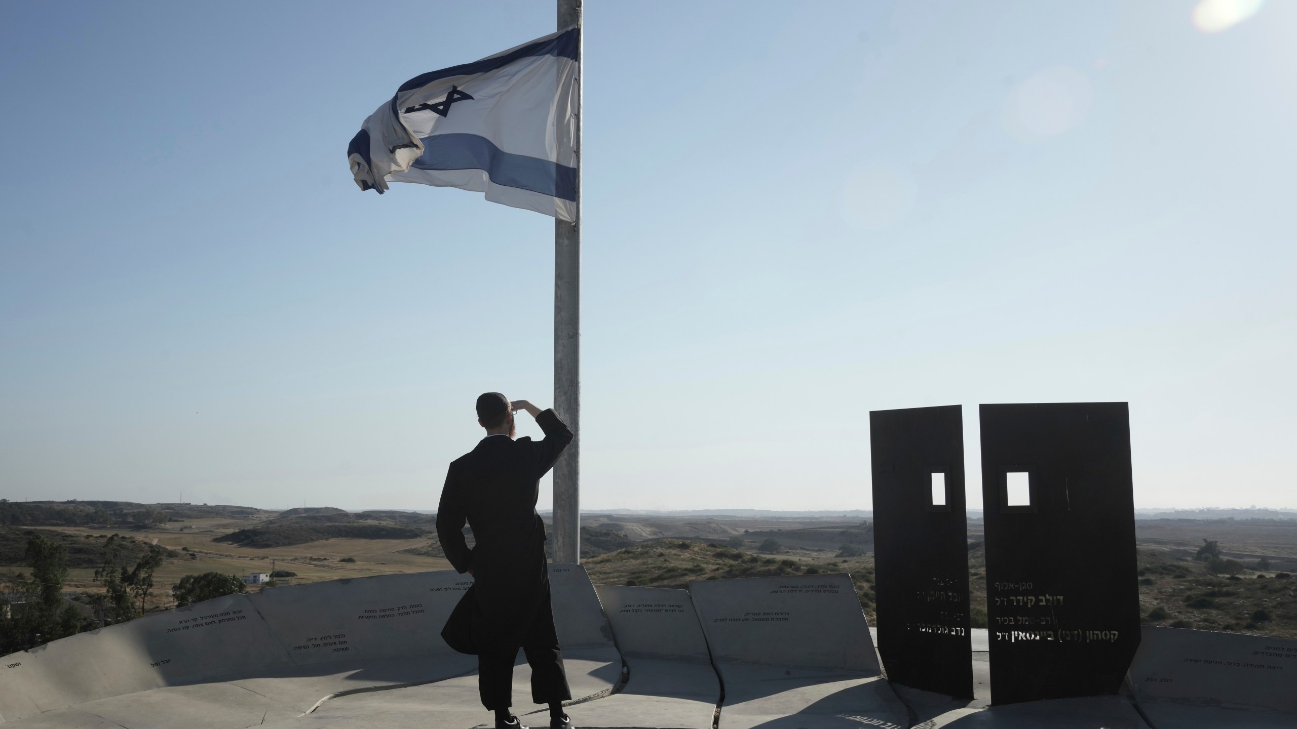 Ultra-orthodox Jewish man looks at the Gaza Strip from an observation point in Sderot, southern Israel, Monday, May 5, 2025. (AP Photo/Maya Alleruzzo)