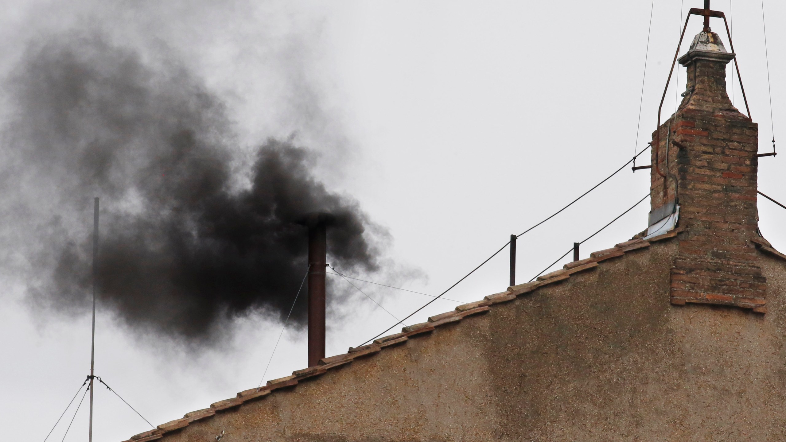 FILE - Black smoke emerges from the chimney on the Sistine Chapel as cardinals voted on the second day of the conclave to elect a pope in St. Peter's Square at the Vatican, Wednesday, March 13, 2013. (AP Photo/Michael Sohn, File)