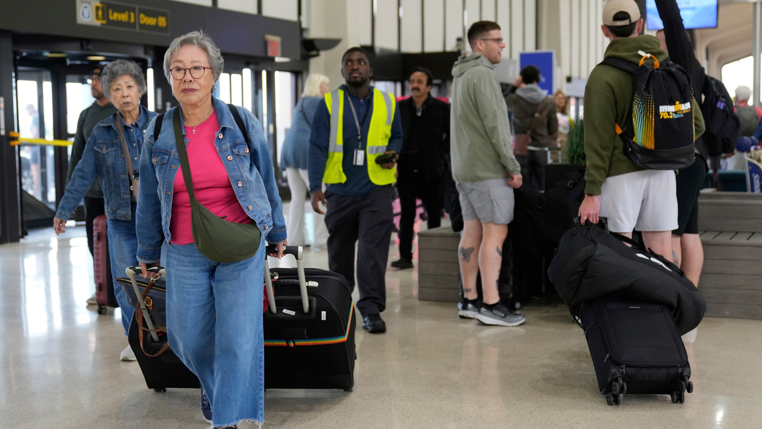 People prepare to board flights at Newark Liberty International Airport in Newark, N.J., Monday, May 5, 2025. (AP Photo/Seth Wenig)