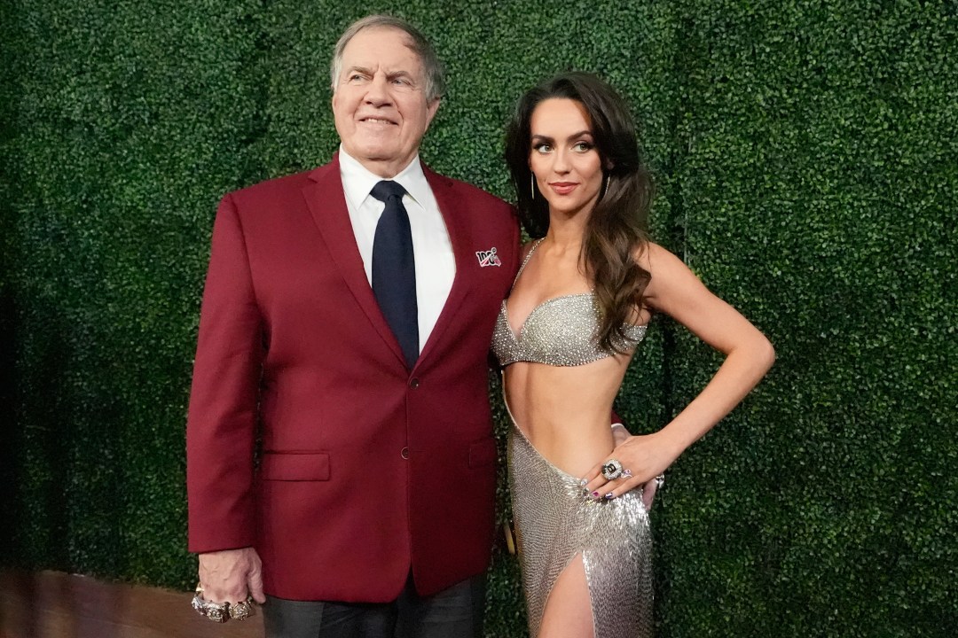 Bill Belichick and Jordon Hudson pose for photos at an event