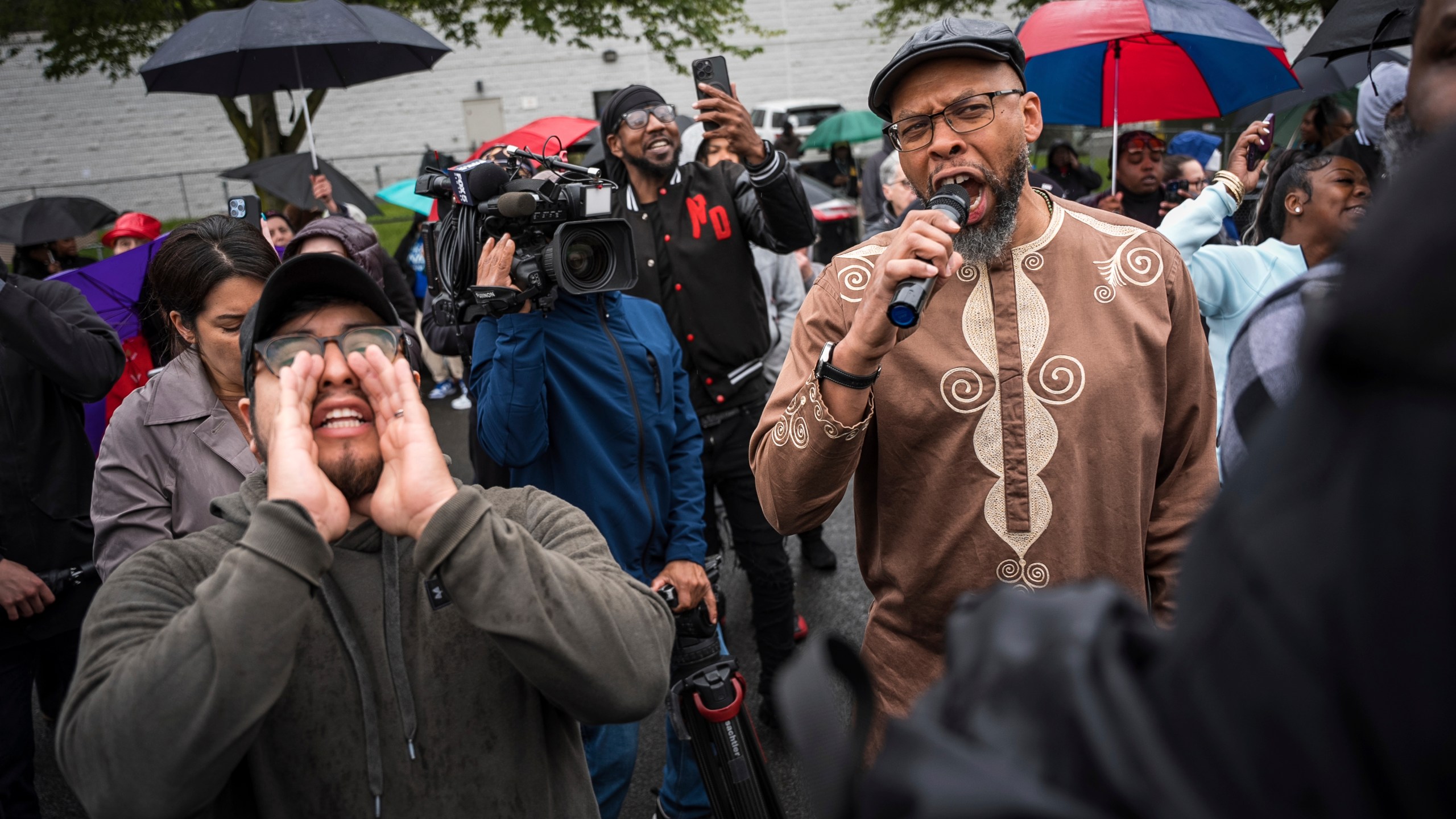 Protestors shout "Let him out" to demand the release of Newark Mayor Ras Baraka after his arrest while protesting outside an ICE detention prison, Friday, May 9, 2025, in Newark, N.J, (AP Photo/Angelina Katsanis)