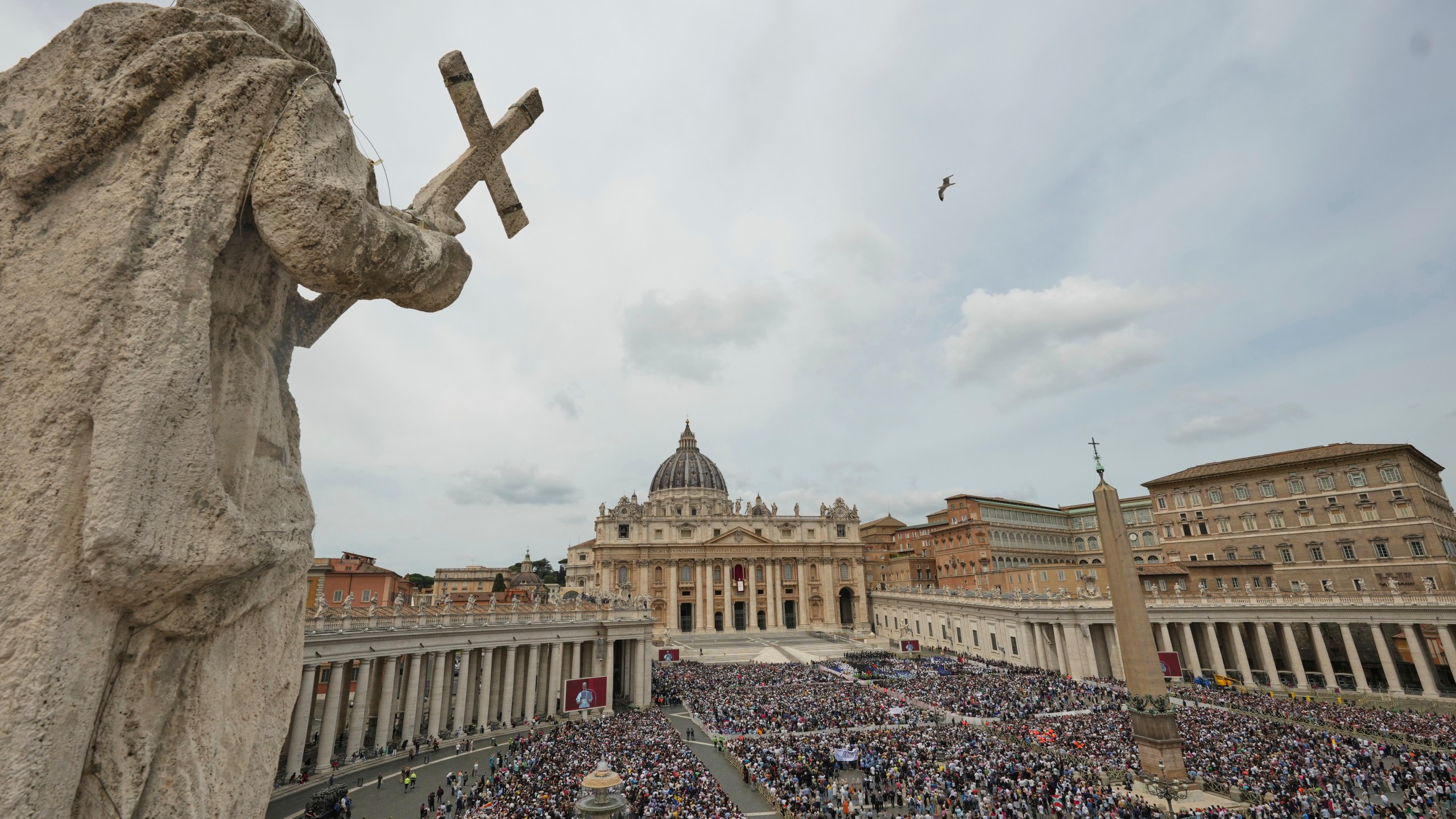 Pope Leo XIV appears at the central balcony of St. Peter's Basilica for his first Sunday blessing after his election, in St. Peter's Square at the Vatican, Sunday May 11, 2025. (AP Photo/Alessandra Tarantino)