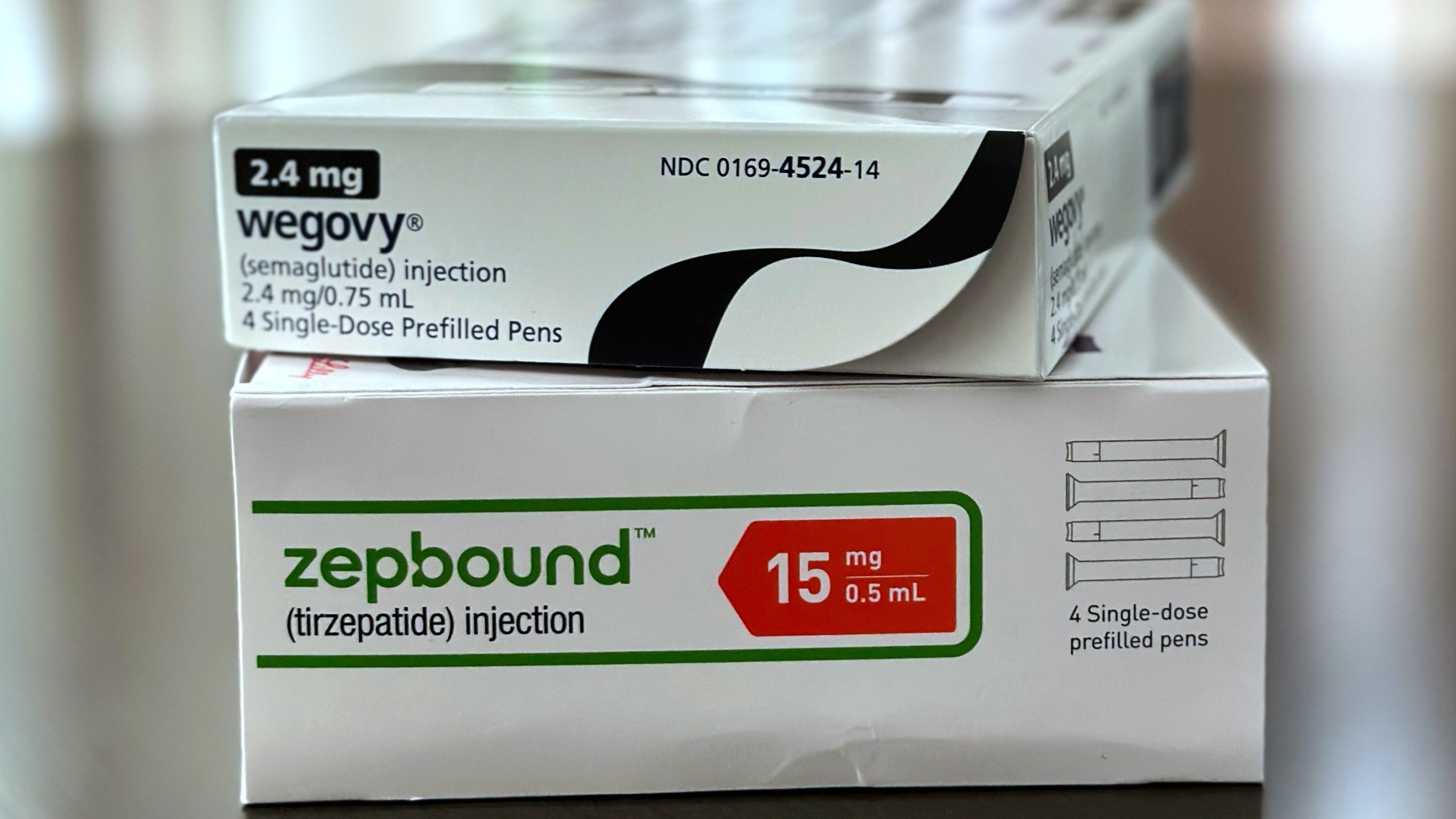 Two boxes of obesity drug Wegovy and Zepbound stacked on each other