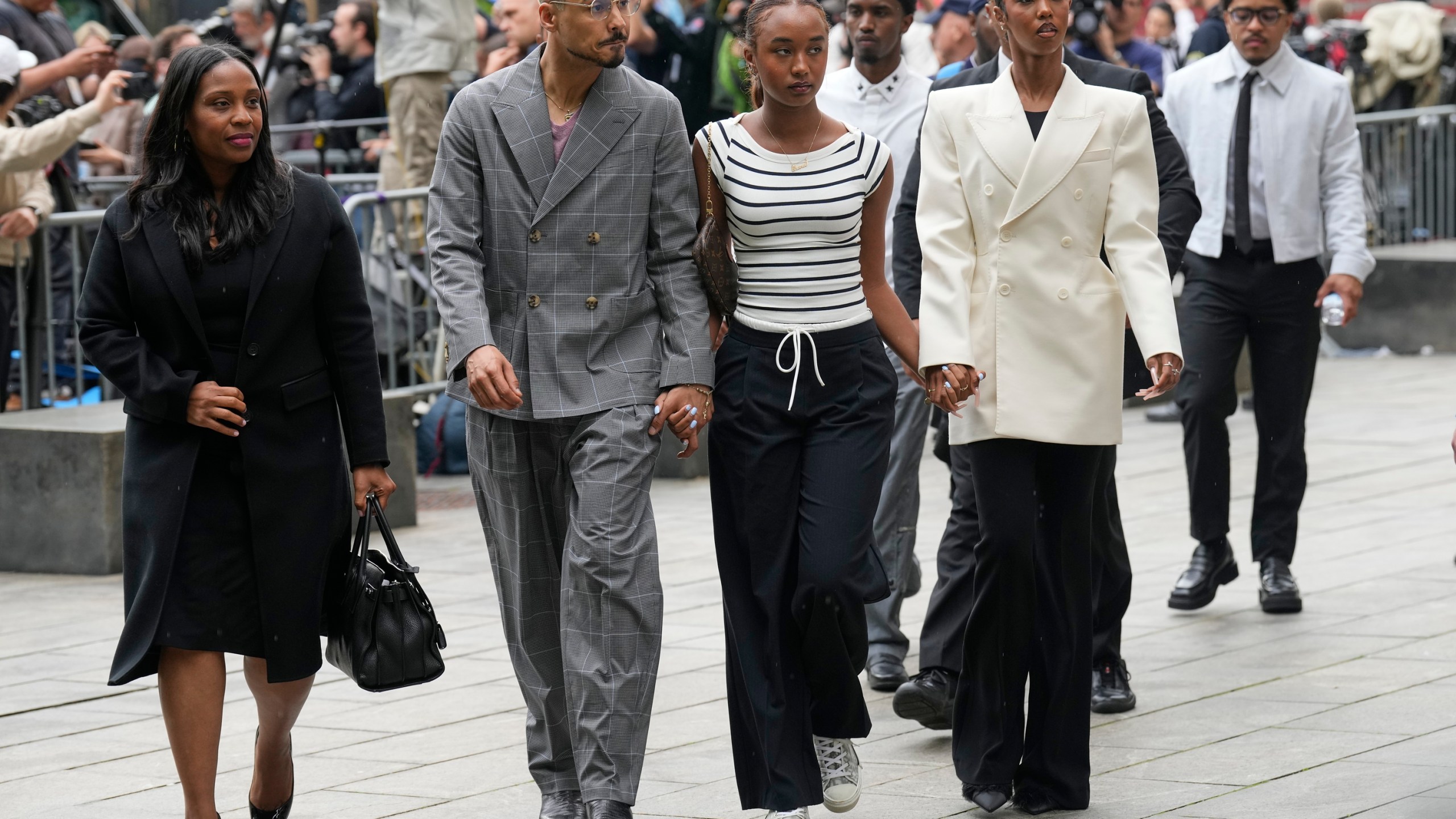 Quincy Combs, second from left, and Chance Combs center, arrive at Manhattan federal court, Tuesday, May 13, 2025, in New York. (AP Photo/Seth Wenig)