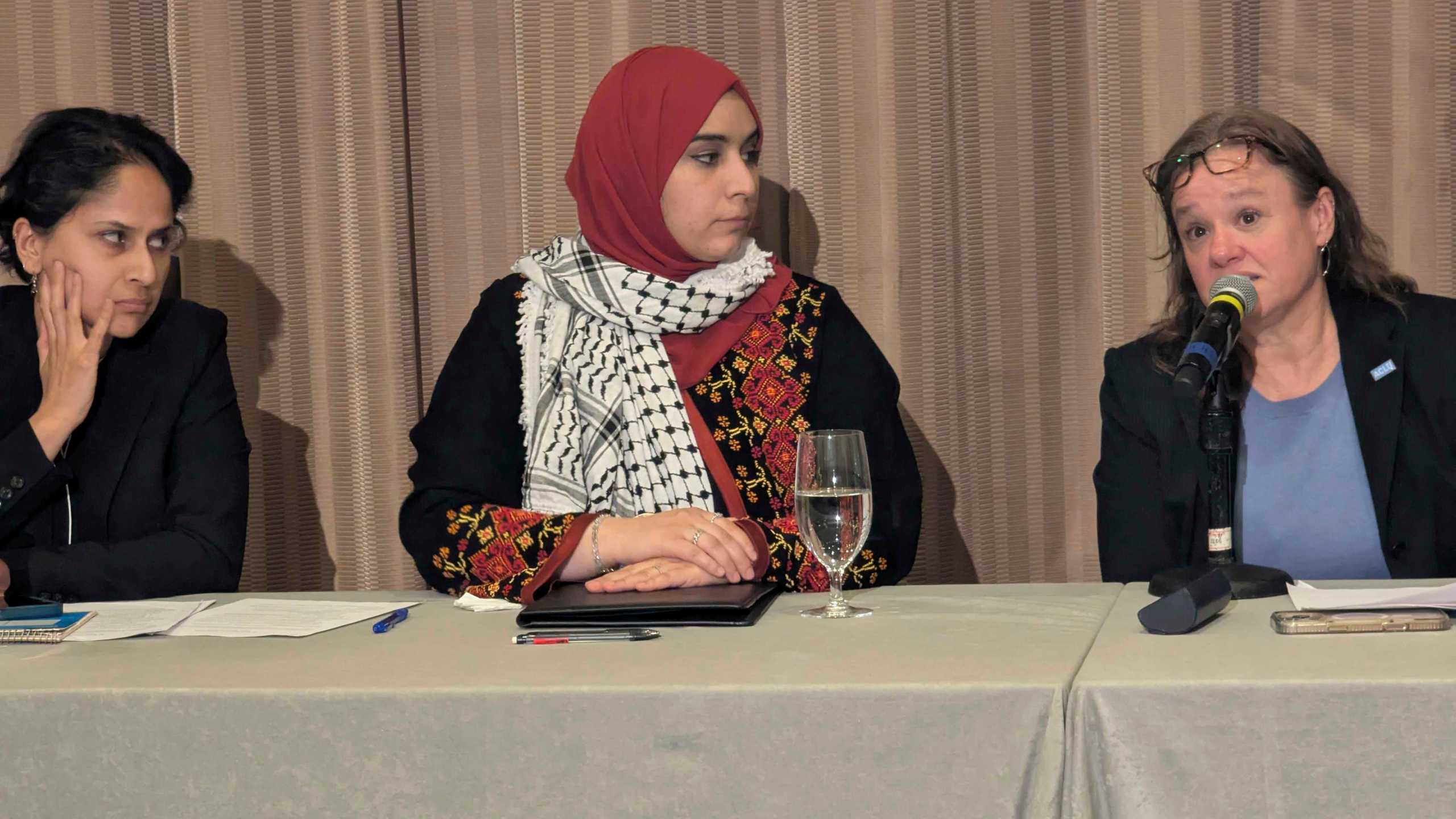 Mapheze Saleh, center, wife of arrested and detained Georgetown University scholar Badar Khan Suri, listens as senior immigrant rights attorney at ACLU Virginia Eden Heilman, right, speaks during a press conference about her husband's release following his hearing at Federal District Court for the Eastern District of Virginia, in Alexandria, Va., Thursday, May 14, 2025 (AP Photo/Nathan Ellgren)