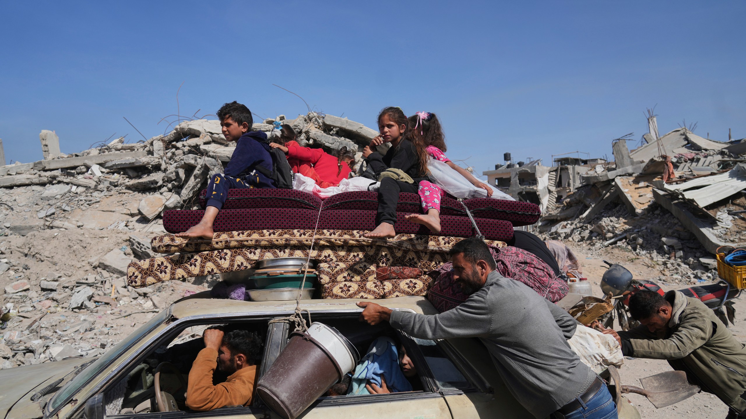 Displaced Palestinians fleeing Beit Lahia amid ongoing Israeli military operations in the Gaza Strip arrive in Jabalia, northern Gaza, on Friday, May 16, 2025. (AP Photo/Jehad Alshrafi)