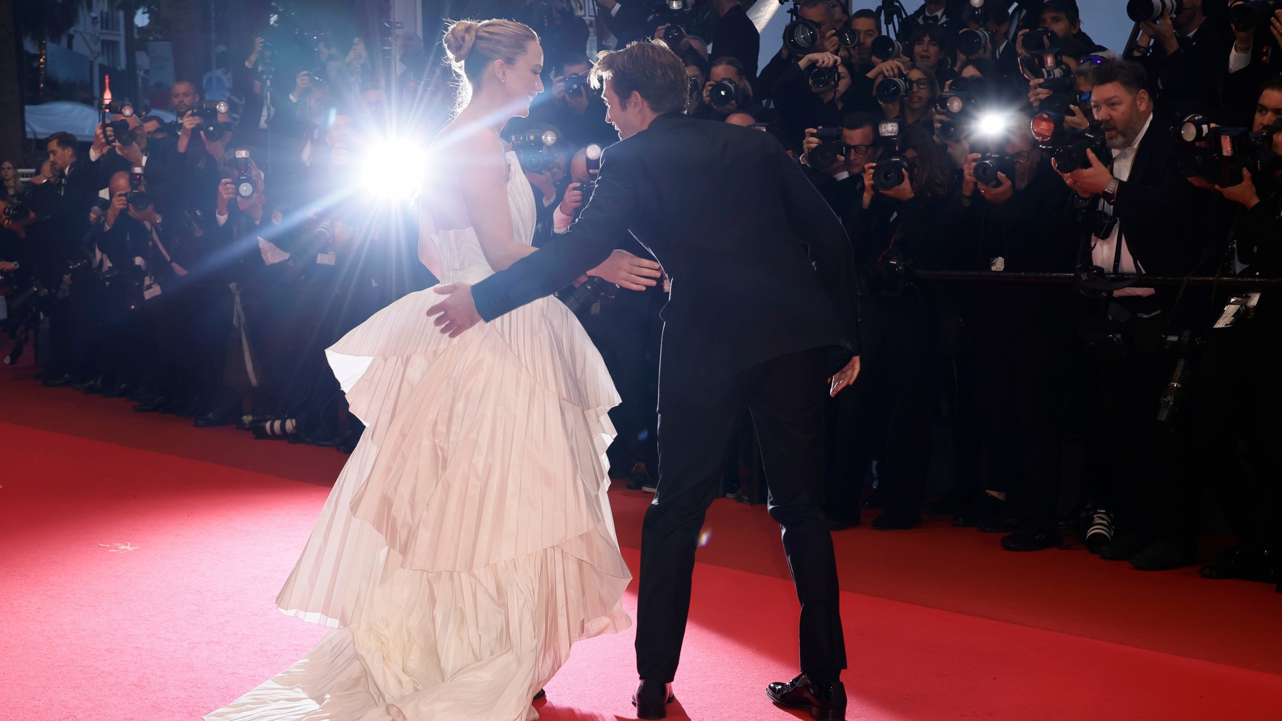 Jennifer Lawrence, left, and Robert Pattinson pose for photographers upon arrival at the premiere of the film 'Die, My Love' at the 78th international film festival, Cannes, southern France, Saturday, May 17, 2025. (Photo by Joel C Ryan/Invision/AP)