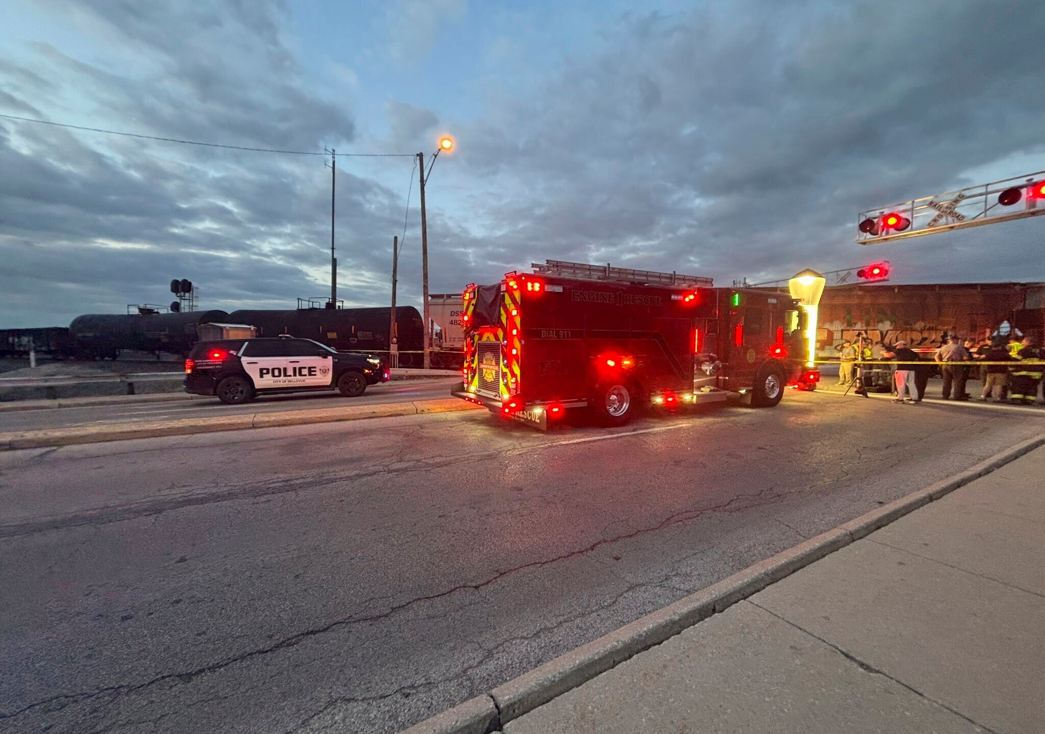 In this photo provided by Emerson Young, first responders are at the scene where a train sits idle on tracks after striking multiple pedestrians Sunday evening, May 18, 2025, in Fremont, Ohio. (Emerson Young via AP)