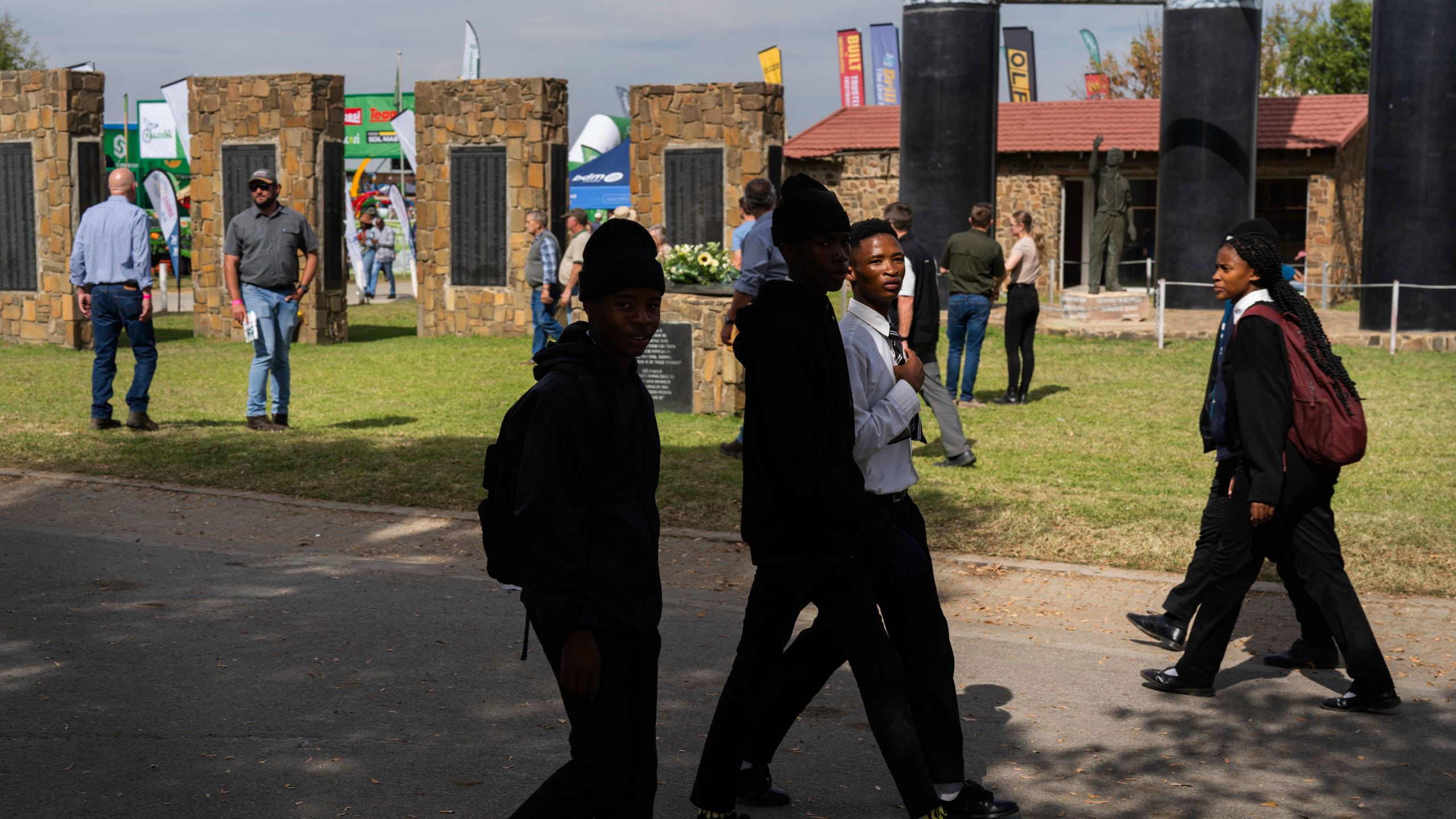 Visitors at the Nampo agricultural fair, one of the largest in the southern hemisphere, walk past the wall of remembrance, a tribute to farmers killed since 1961, near Bothaville, South Africa, May 15, 2025. (AP Photo/Jerome Delay)
