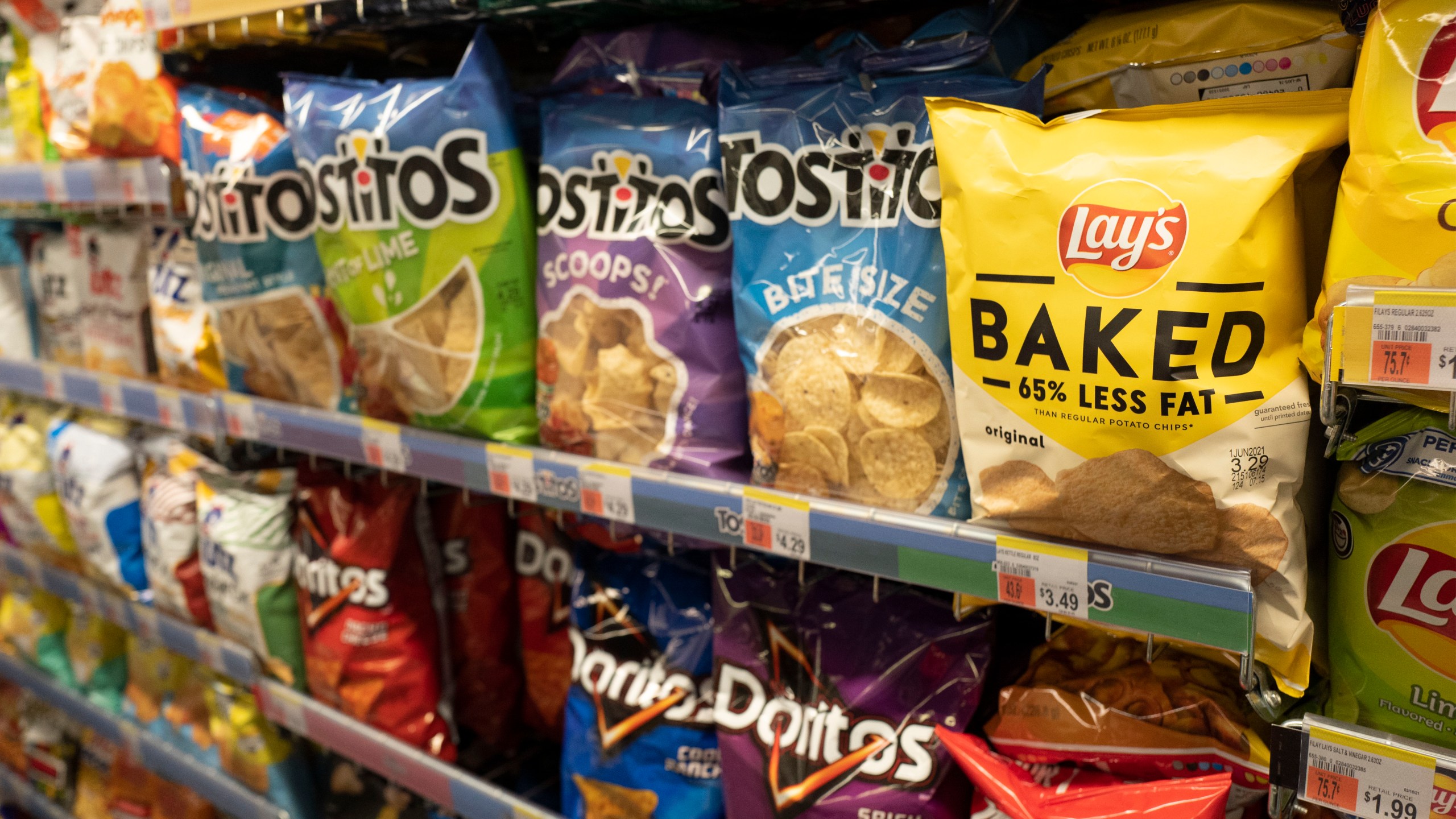 FILE - Potato chips are displayed in pharmacy Duane Reade by Walgreens, Thursday, March 25, 2021, in New York. Walgreens reports earnings March 31, 2021. (AP Photo/Mark Lennihan, file)