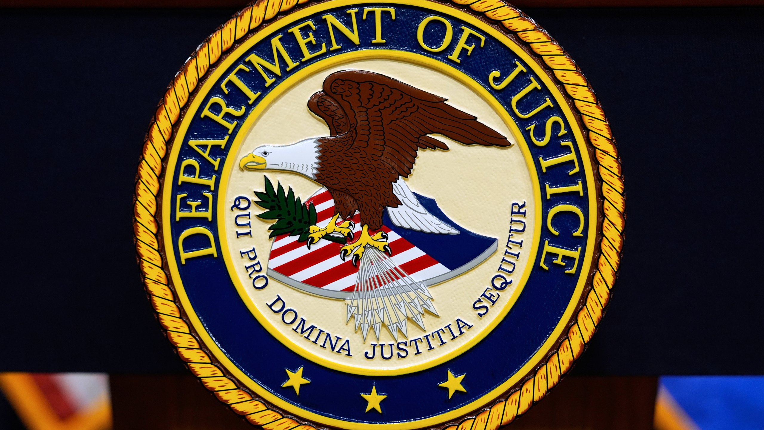 The U.S. Department of Justice logo is seen on a podium before a press conference with Attorney General Pam Bondi, Tuesday, May 6, 2025, at the Justice Department in Washington. (AP Photo/Julia Demaree Nikhinson)