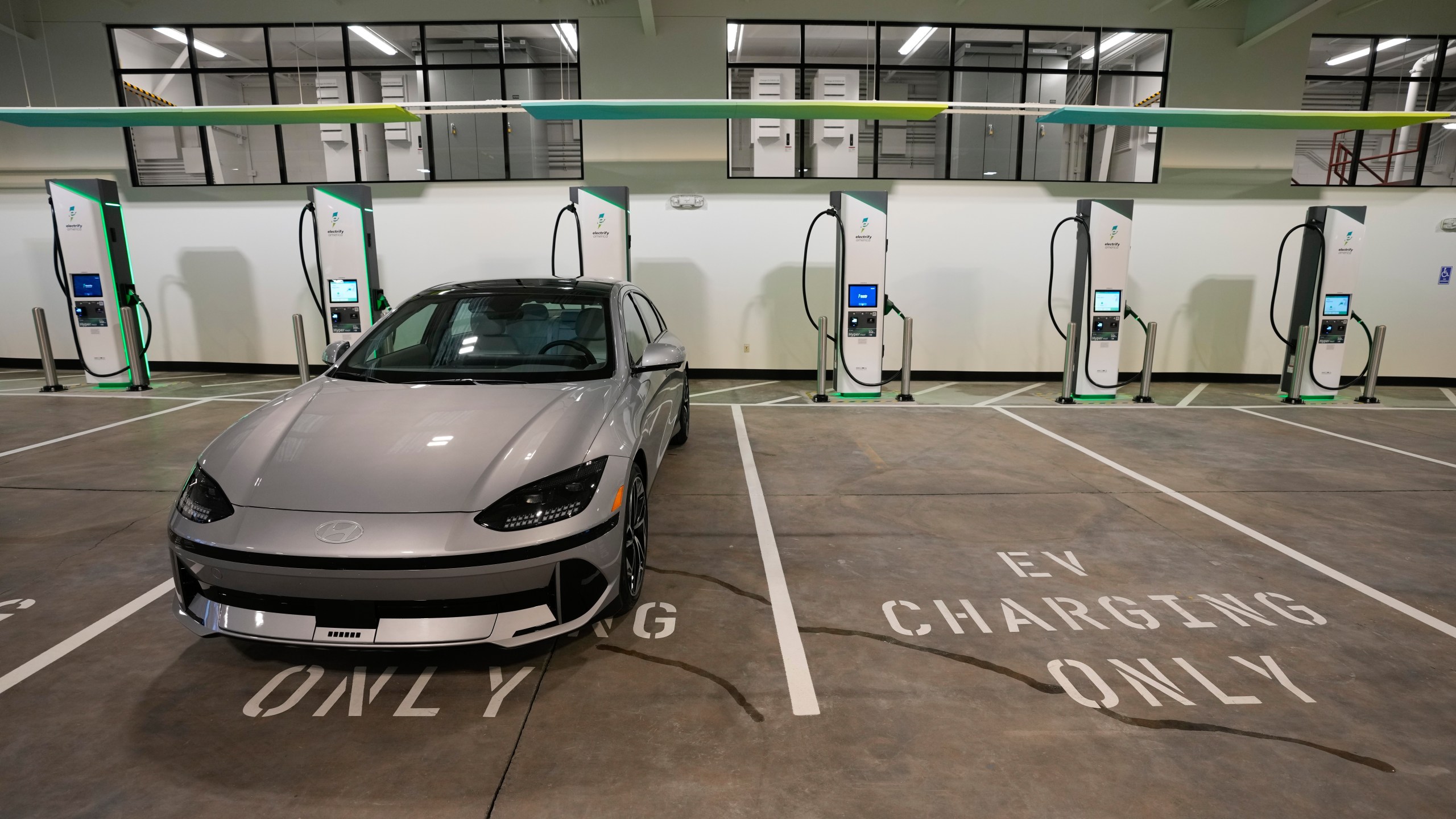 FILE - Charging bays are seen at the new Electrify America indoor electric vehicle charging station in San Francisco, Wednesday, Feb. 7, 2024. (AP Photo/Eric Risberg, File)