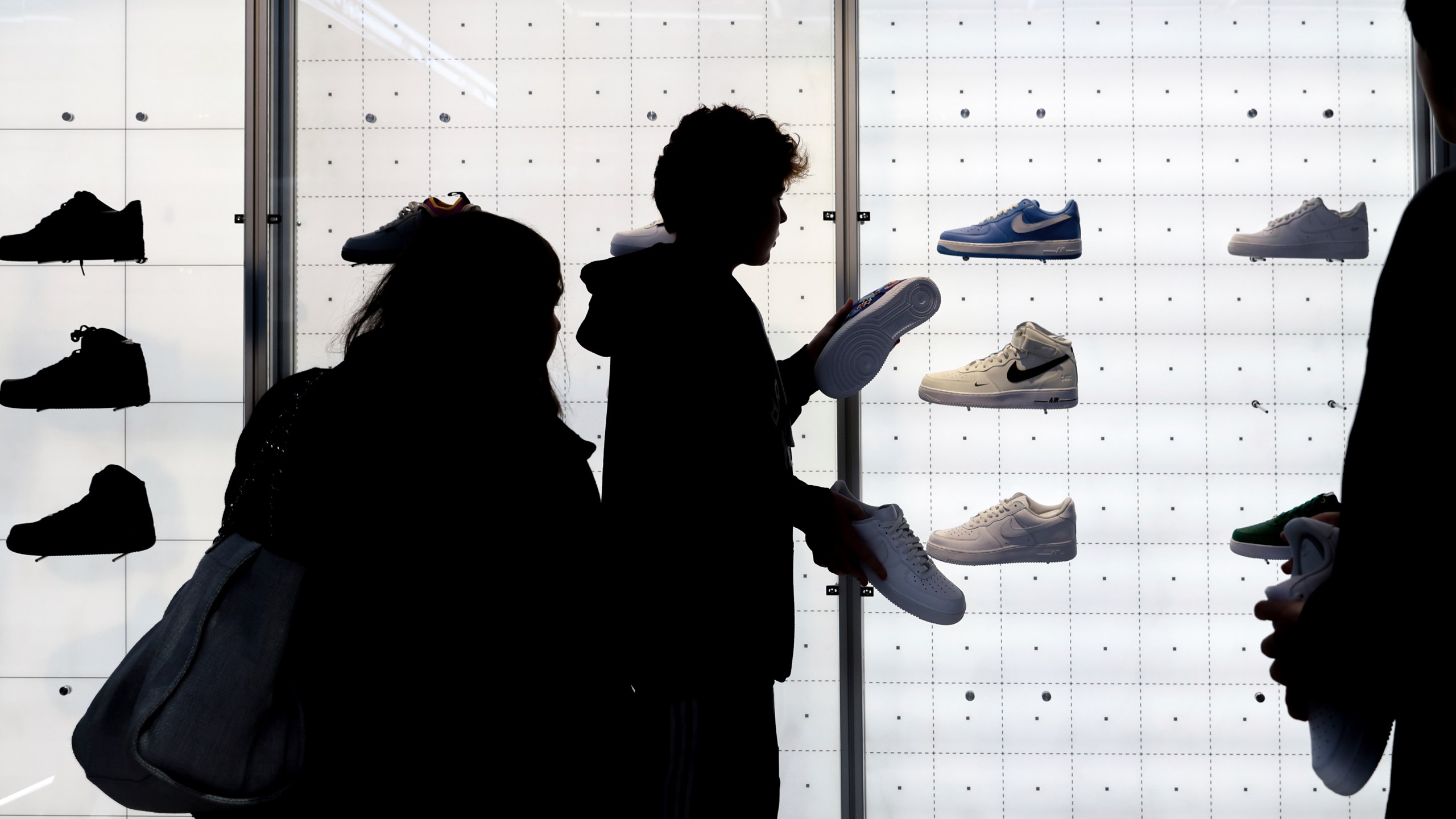 FILE - People shop for shoes in a Nike store on Nov. 25, 2022, in New York. (AP Photo/Julia Nikhinson, File)